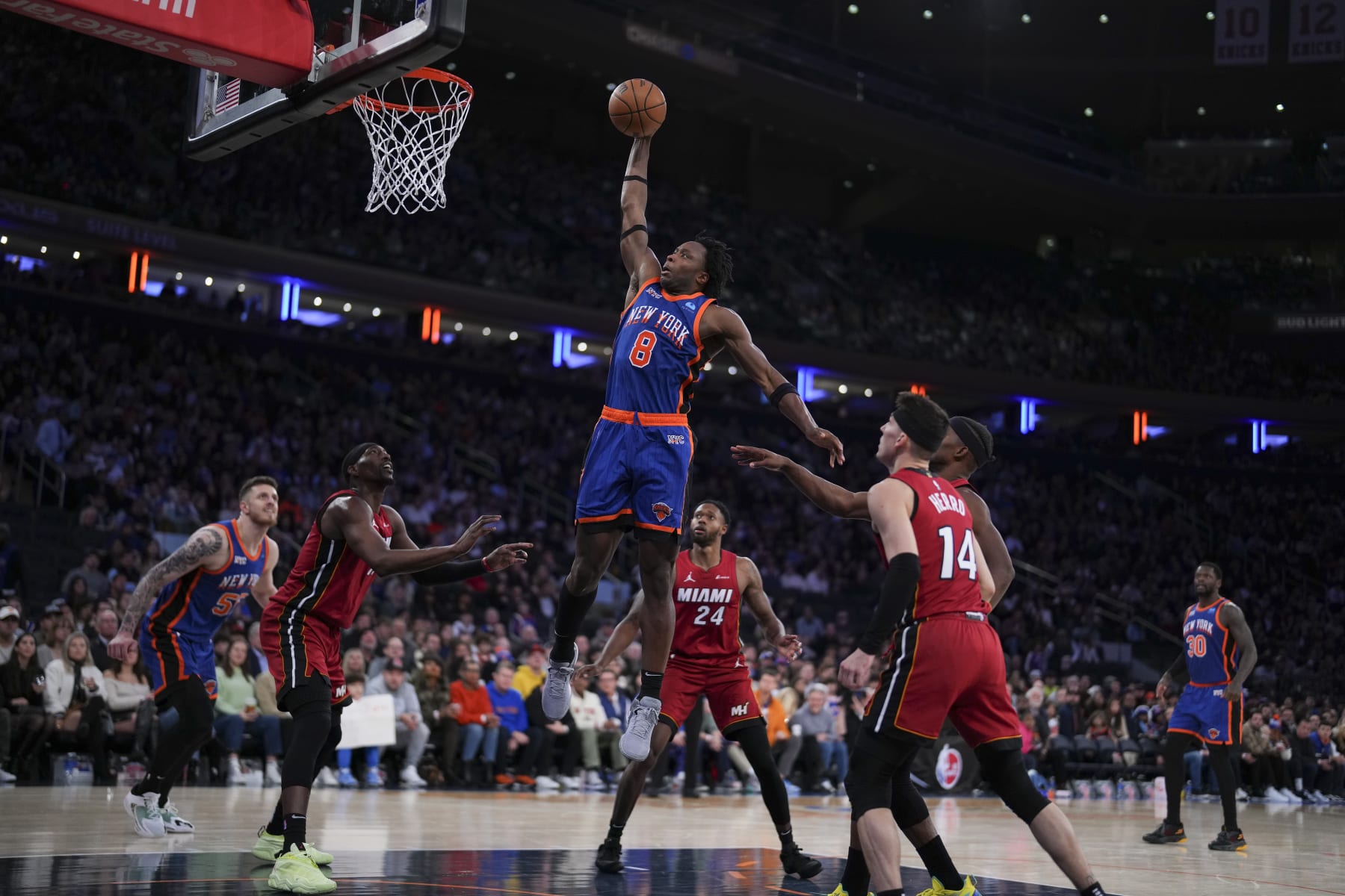 NEW YORK, NEW YORK - JANUARY 27: OG Anunoby #8 of the New York Knicks dunks the ball past Bam Adebayo #13, Haywood Highsmith #24, and Tyler Herro #14 of the Miami Heat in the second half at Madison Square Garden on January 27, 2024 in New York City. The Knicks defeated the Heat 125-109. NOTE TO USER: User expressly acknowledges and agrees that, by downloading and or using this photograph, User is consenting to the terms and conditions of the Getty Images License Agreement. (Photo by Mitchell Leff/Getty Images)