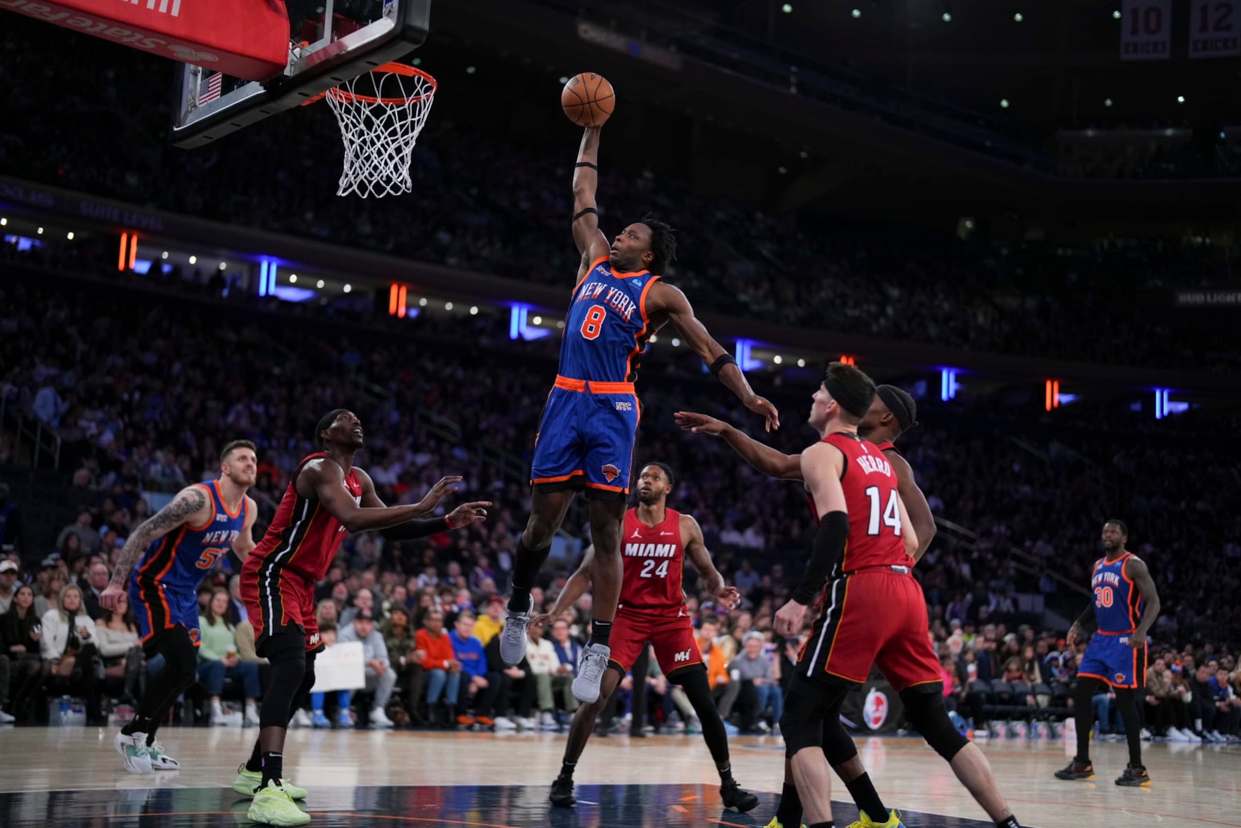 NEW YORK, NEW YORK - JANUARY 27: OG Anunoby #8 of the New York Knicks dunks the ball past Bam Adebayo #13, Haywood Highsmith #24, and Tyler Herro #14 of the Miami Heat in the second half at Madison Square Garden on January 27, 2024 in New York City. The Knicks defeated the Heat 125-109. NOTE TO USER: User expressly acknowledges and agrees that, by downloading and or using this photograph, User is consenting to the terms and conditions of the Getty Images License Agreement. (Photo by Mitchell Leff/Getty Images)