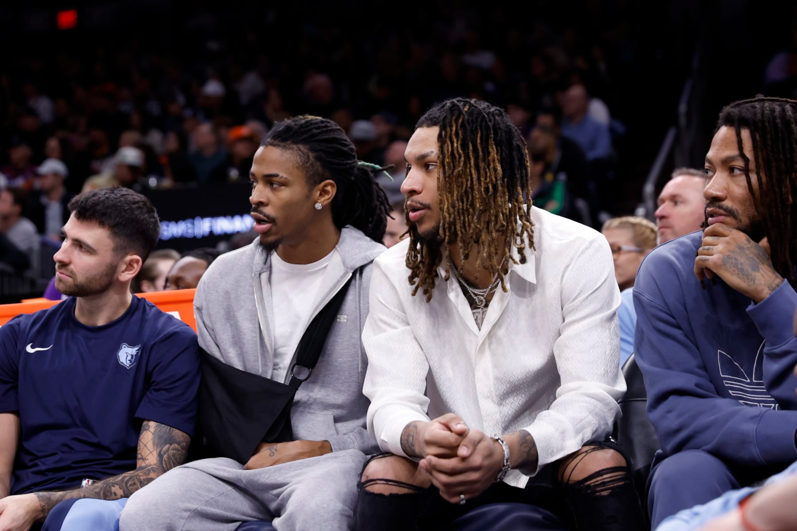 PHOENIX, ARIZONA - JANUARY 07: (L-R) John Konchar #46 of the Memphis Grizzlies, Ja Morant #12, Brandon Clarke #15 and Derrick Rose #23 watch the action during the game against the Phoenix Suns at Footprint Center on January 07, 2024 in Phoenix, Arizona. The Grizzlies defeated the Suns 121-115. NOTE TO USER: User expressly acknowledges and agrees that, by downloading and or using this photograph, User is consenting to the terms and conditions of the Getty Images License Agreement.  (Photo by Chris Coduto/Getty Images)