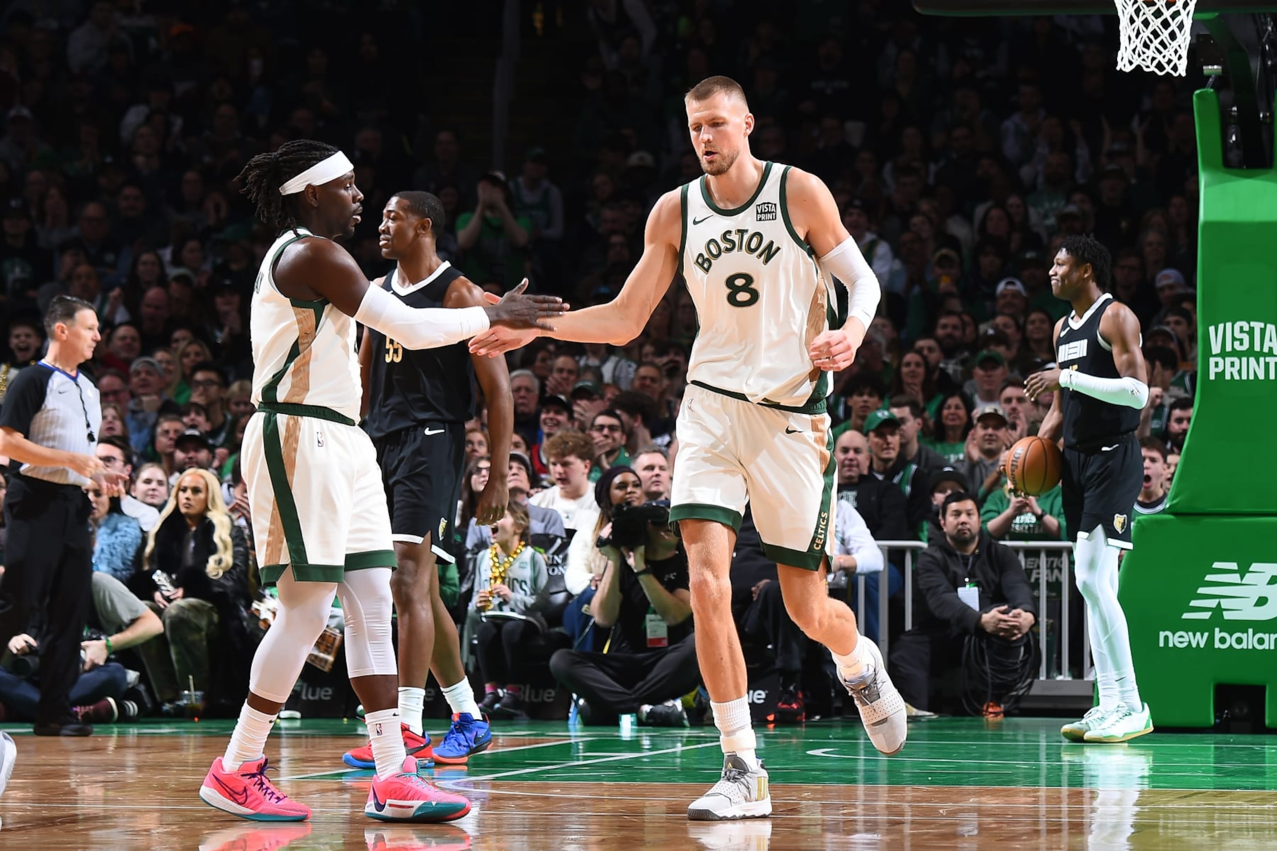BOSTON, MA - FEBRUARY 4:  Jrue Holiday #4 high fives Kristaps Porzingis #8 of the Boston Celtics during the game against the Memphis Grizzlies on February 4, 2024 at the TD Garden in Boston, Massachusetts. NOTE TO USER: User expressly acknowledges and agrees that, by downloading and or using this photograph, User is consenting to the terms and conditions of the Getty Images License Agreement. Mandatory Copyright Notice: Copyright 2024 NBAE  (Photo by Brian Babineau/NBAE via Getty Images)