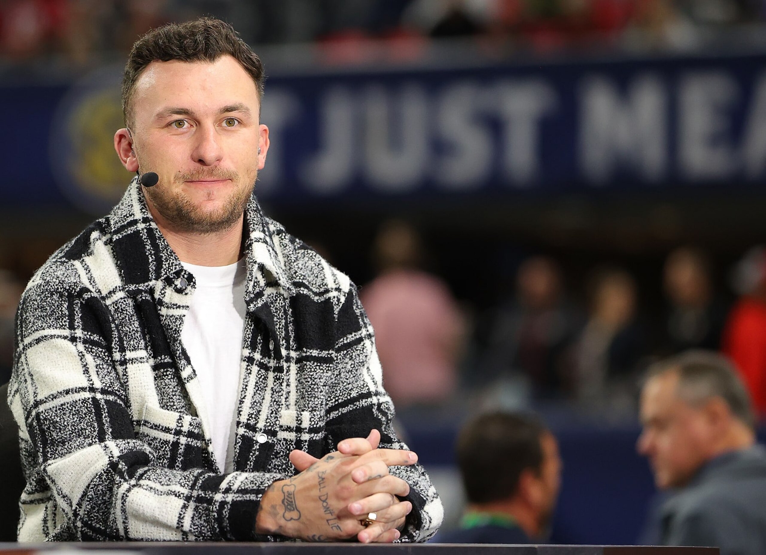 ATLANTA, GEORGIA - DECEMBER 03:  Football Quarterback Johnny Manziel talks onset prior to the SEC Championship game between the LSU Tigers and the Georgia Bulldogs at Mercedes-Benz Stadium on December 03, 2022 in Atlanta, Georgia. (Photo by Kevin C. Cox/Getty Images)
