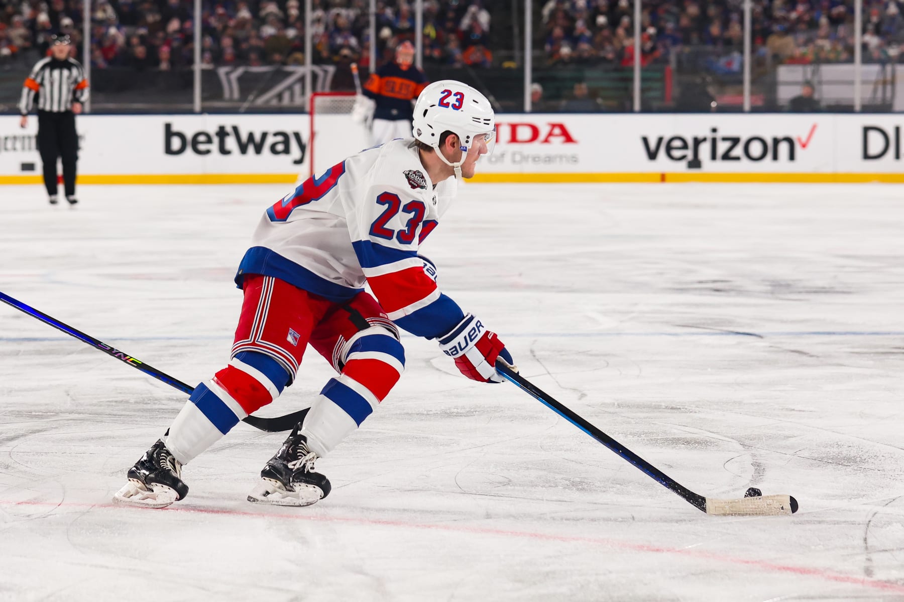 EAST RUTHERFORD, NJ - FEBRUARY 18: New York Rangers defenseman Adam Fox (23) skates with the puck during a NHL Stadium Series game between the New York Rangers and New York Islanders on February 18, 2024 at Metlife Stadium in East Rutherford, New Jersey. (Photo by Andrew Mordzynski/Icon Sportswire via Getty Images)