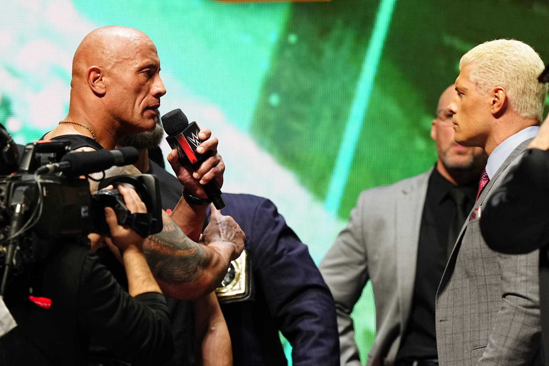 LAS VEGAS, NV - FEBRUARY 08:  Dwayne "The Rock" Johnson and Cody Rhodes face-off on stage during the WWE Wrestlemania XL Kickoff on February 08, 2024, at T-Mobile Arena in Las Vegas, NV. (Photo by Louis Grasse/PXimages/Icon Sportswire via Getty Images)