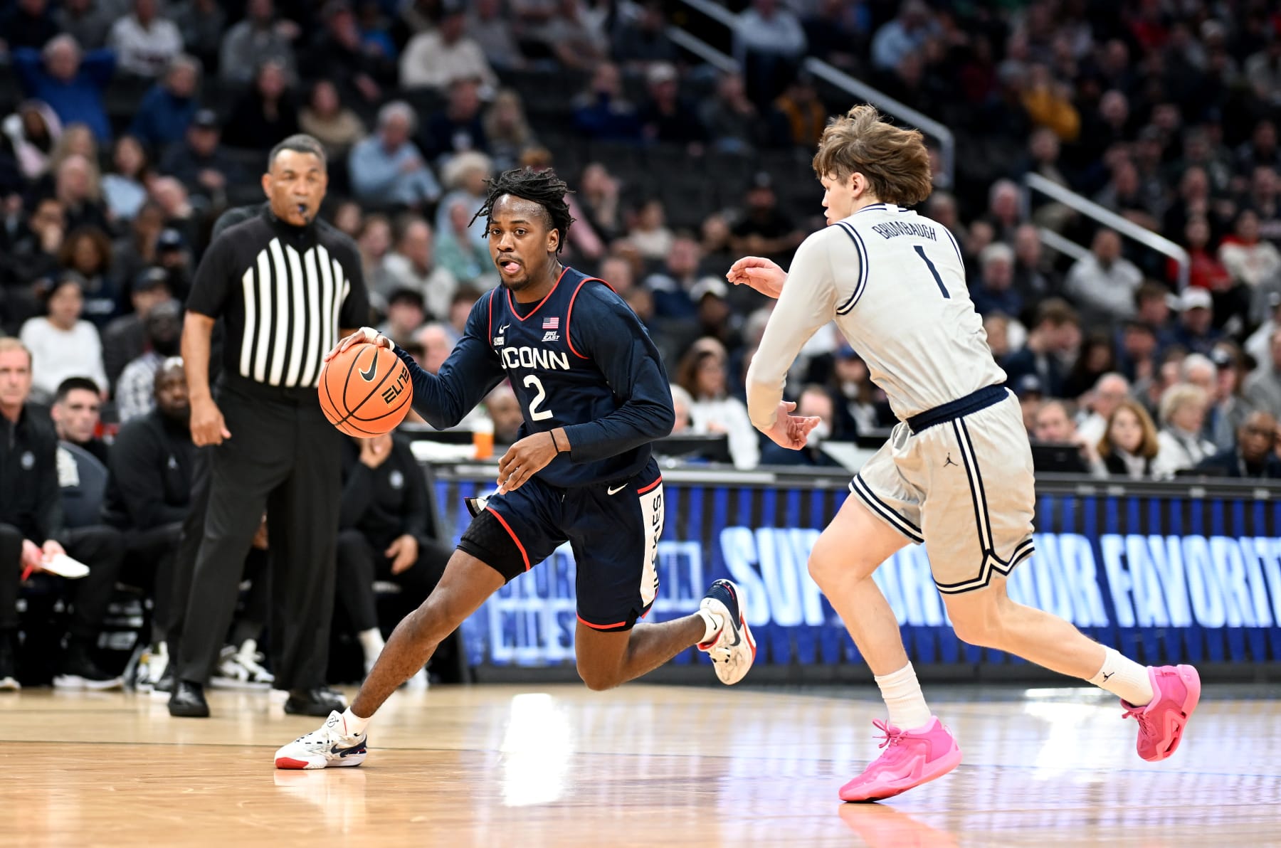WASHINGTON, DC - FEBRUARY 10: Tristen Newton #2 of the Connecticut Huskies handles the ball against Rowan Brumbaugh #1 of the Georgetown Hoyas at Capital One Arena on February 10, 2024 in Washington, DC. (Photo by G Fiume/Getty Images)