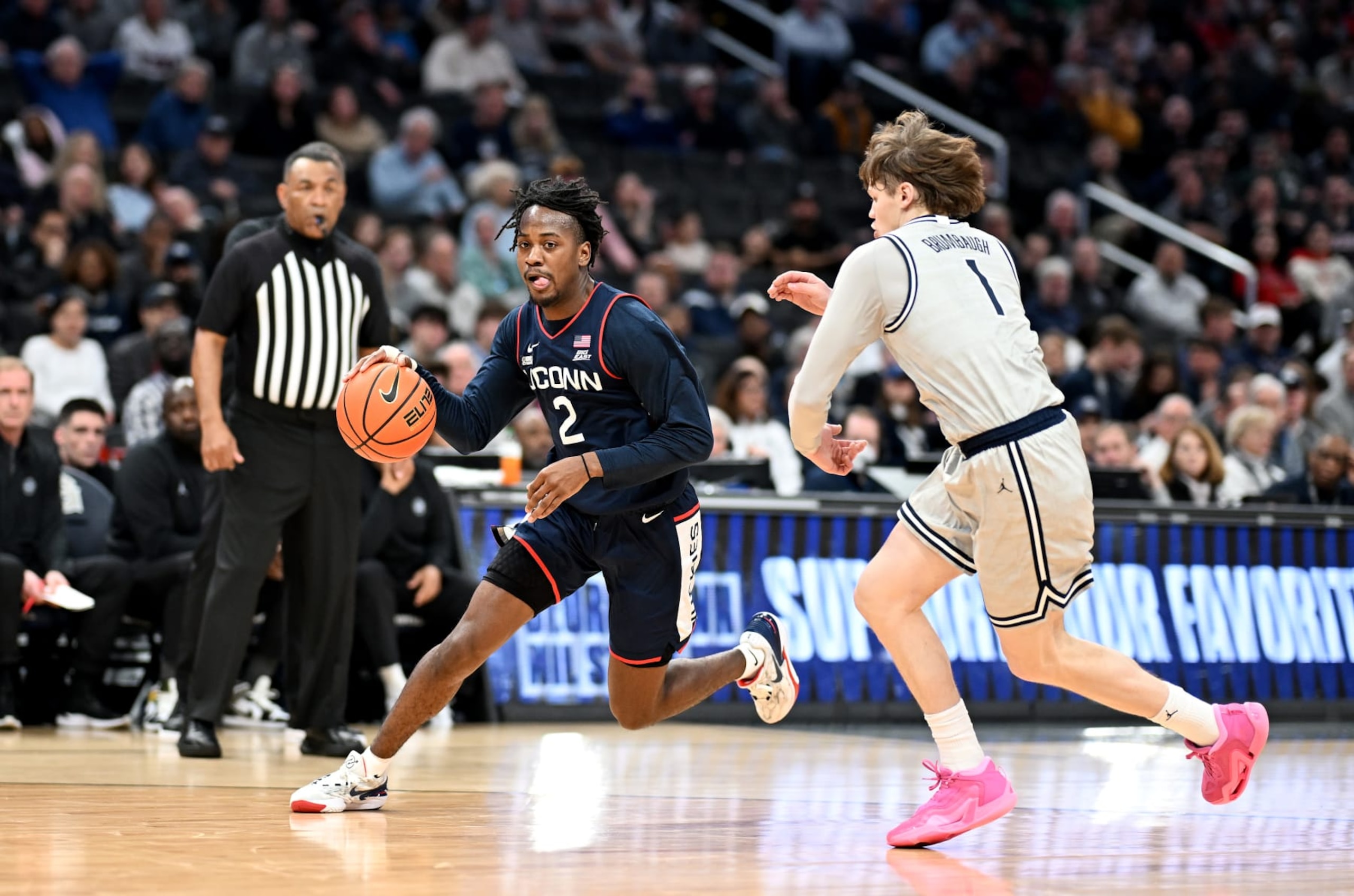 WASHINGTON, DC - FEBRUARY 10: Tristen Newton #2 of the Connecticut Huskies handles the ball against Rowan Brumbaugh #1 of the Georgetown Hoyas at Capital One Arena on February 10, 2024 in Washington, DC. (Photo by G Fiume/Getty Images)