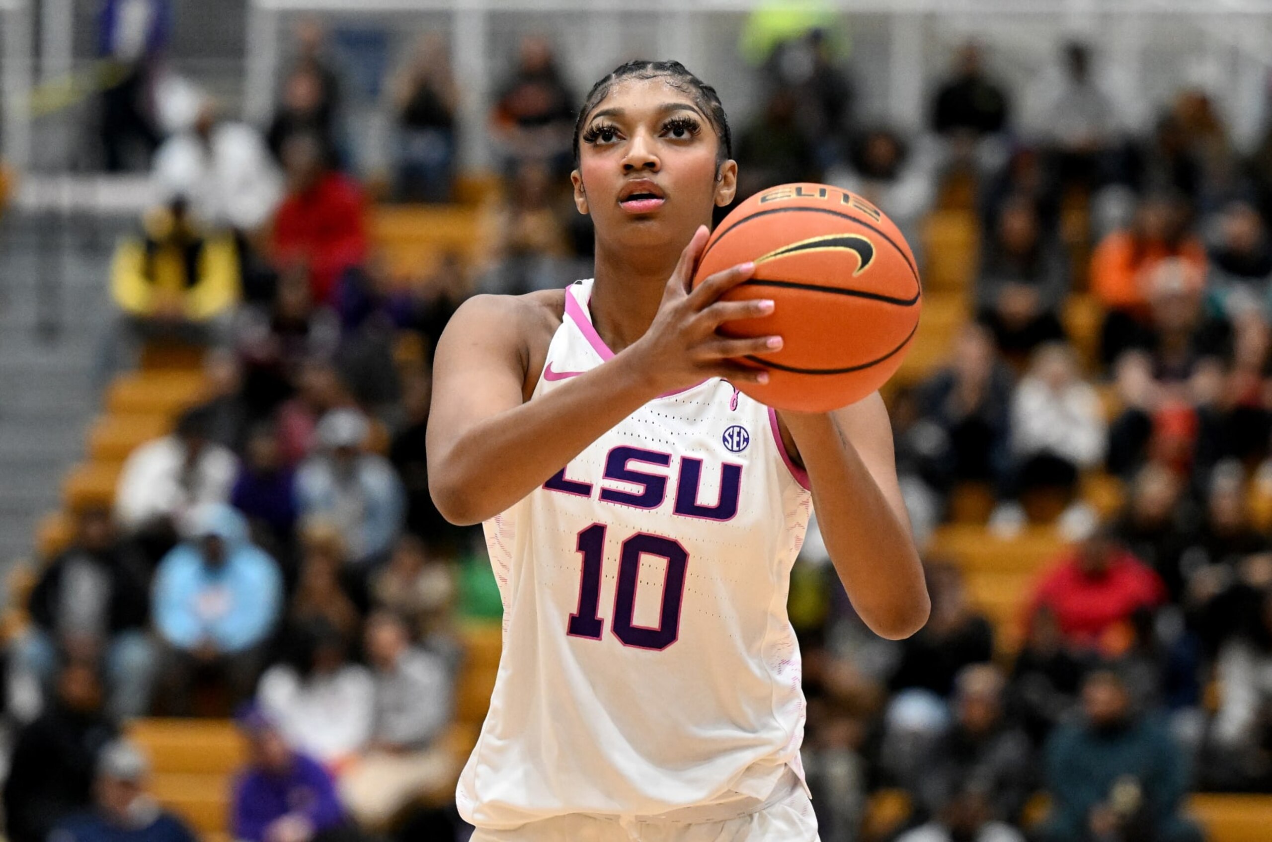 BALTIMORE, MARYLAND - DECEMBER 20: Angel Reese #10 of the LSU Lady Tigers shoots a free throw against the Coppin State Eagles at Coppin State University on December 20, 2023 in Baltimore, Maryland. (Photo by G Fiume/Getty Images)