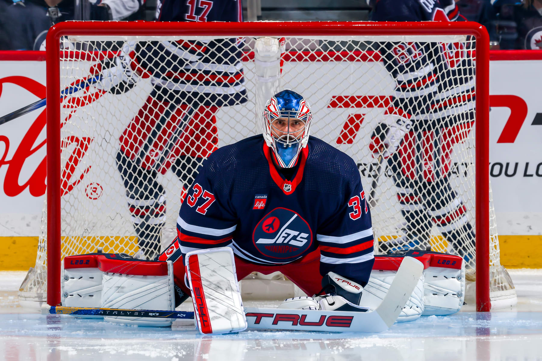 WINNIPEG, CANADA - FEBRUARY 14: Goaltender Connor Hellebuyck #37 of the Winnipeg Jets warms up in his crease prior to NHL action against the San Jose Sharks at Canada Life Centre on February 14, 2024 in Winnipeg, Manitoba, Canada. (Photo by Jonathan Kozub/NHLI via Getty Images)