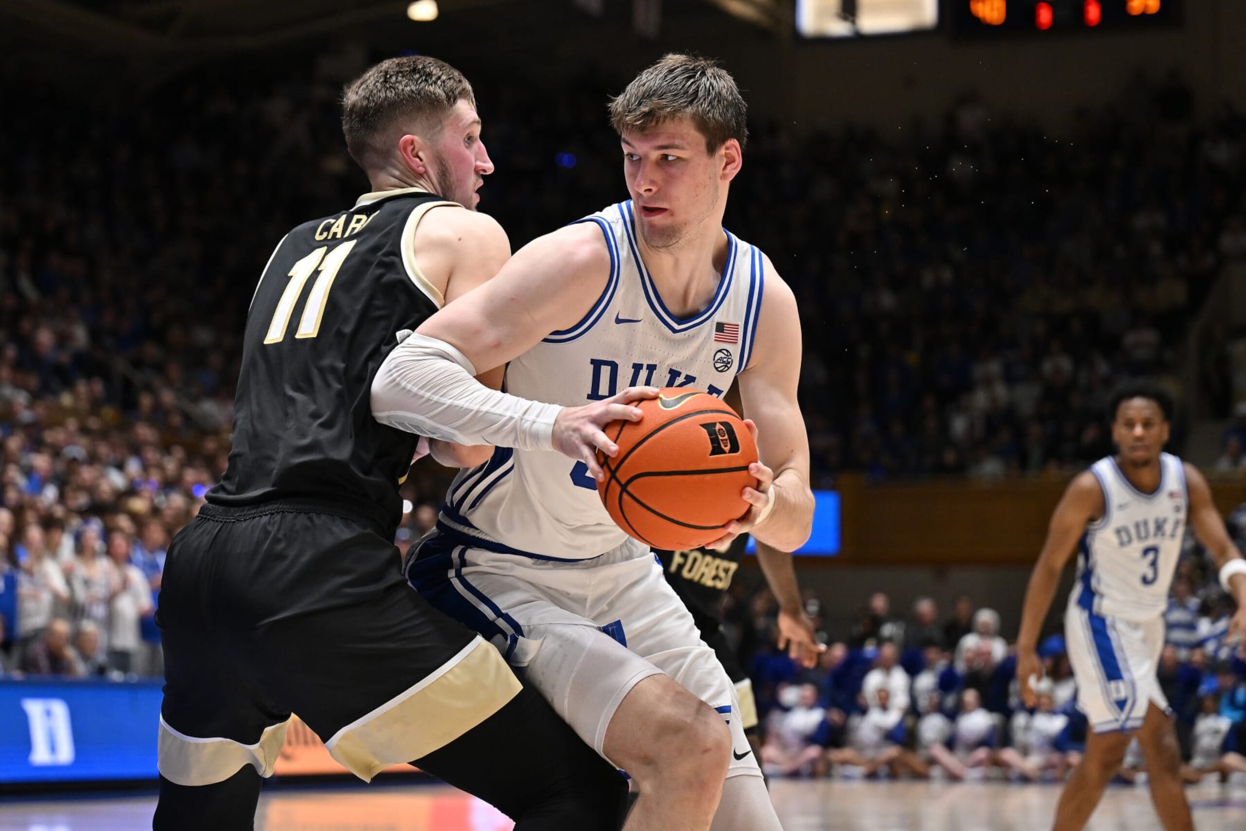 DURHAM, NORTH CAROLINA - FEBRUARY 12: Kyle Filipowski #30 of the Duke Blue Devils moves the ball against Andrew Carr #11 of the Wake Forest Demon Deacons during the game at Cameron Indoor Stadium on February 12, 2024 in Durham, North Carolina. Duke won 77-69. (Photo by Grant Halverson/Getty Images) DURHAM, NORTH CAROLINA - FEBRUARY 12: Kyle Filipowski #30 of the Duke Blue Devils moves the ball against Andrew Carr #11 of the Wake Forest Demon Deacons during the game at Cameron Indoor Stadium on February 12, 2024 in Durham, North Carolina. Duke won 77-69. (Photo by Grant Halverson/Getty Images)