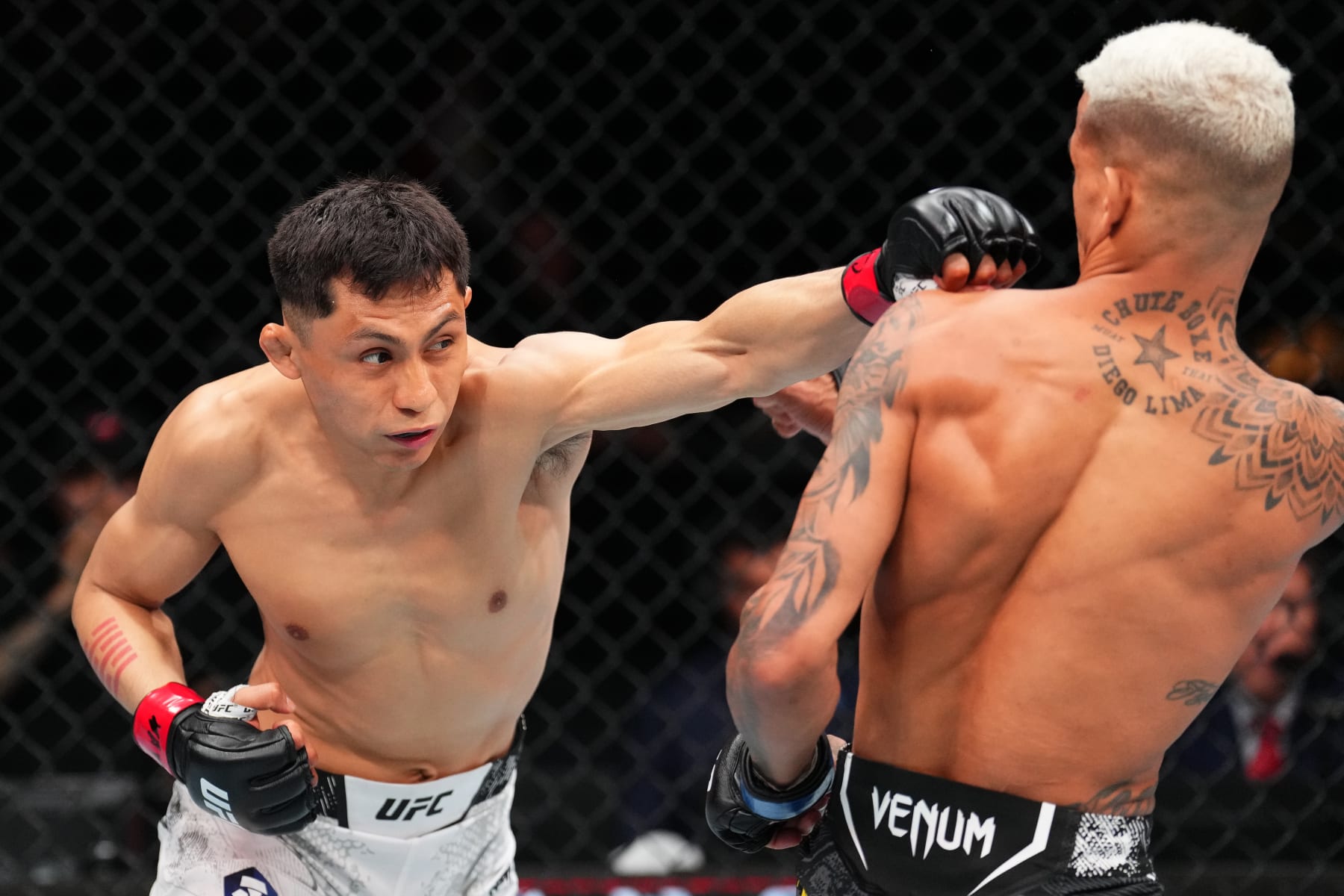 MEXICO CITY, MEXICO - FEBRUARY 24: (L-R) Victor Altamirano of Mexico punches Felipe dos Santos of Brazil in a flyweight fight during the UFC Fight Night event at Arena CDMX on February 24, 2024 in Mexico City, Mexico. (Photo by Josh Hedges/Zuffa LLC via Getty Images)