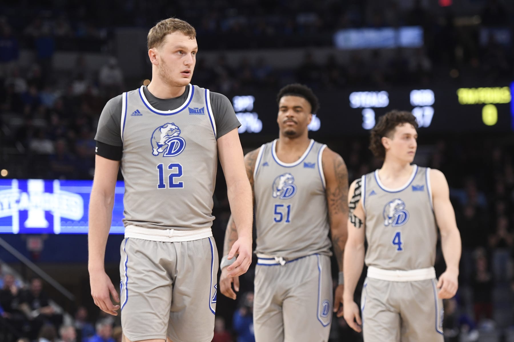 Drake's Tucker DeVries (12), Darnell Brodie (51) and Conor Enright (4)