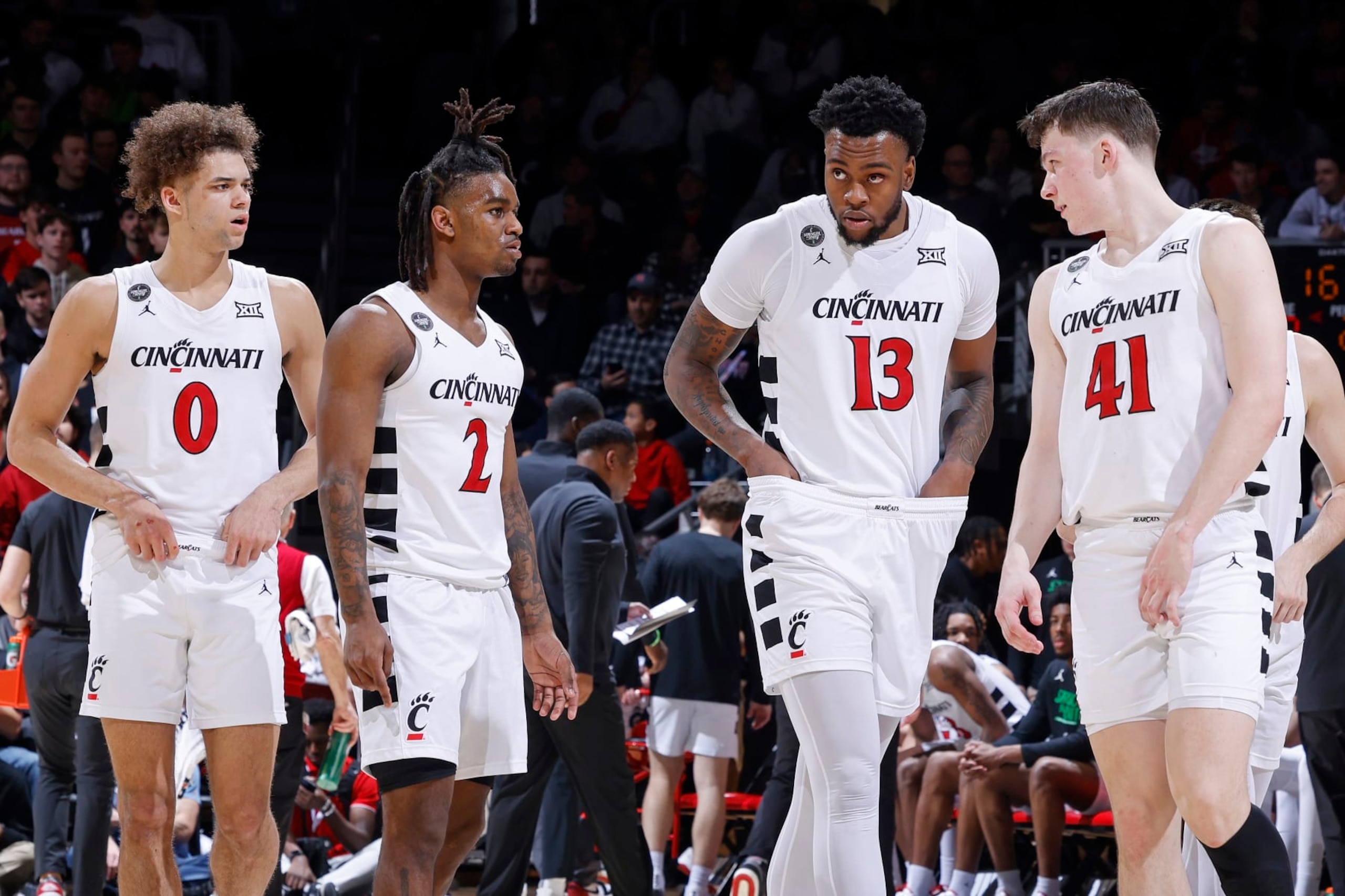 CINCINNATI, OH - FEBRUARY 13: Cincinnati Bearcats guard Dan Skillings Jr. (0), guard Jizzle James (2), forward Jamille Reynolds (13) and guard Simas Lukosius (41) look on during a college basketball game against the Iowa State Cyclones on February 13, 2024 at Fifth Third Arena in Cincinnati, Ohio. (Photo by Joe Robbins/Icon Sportswire via Getty Images)