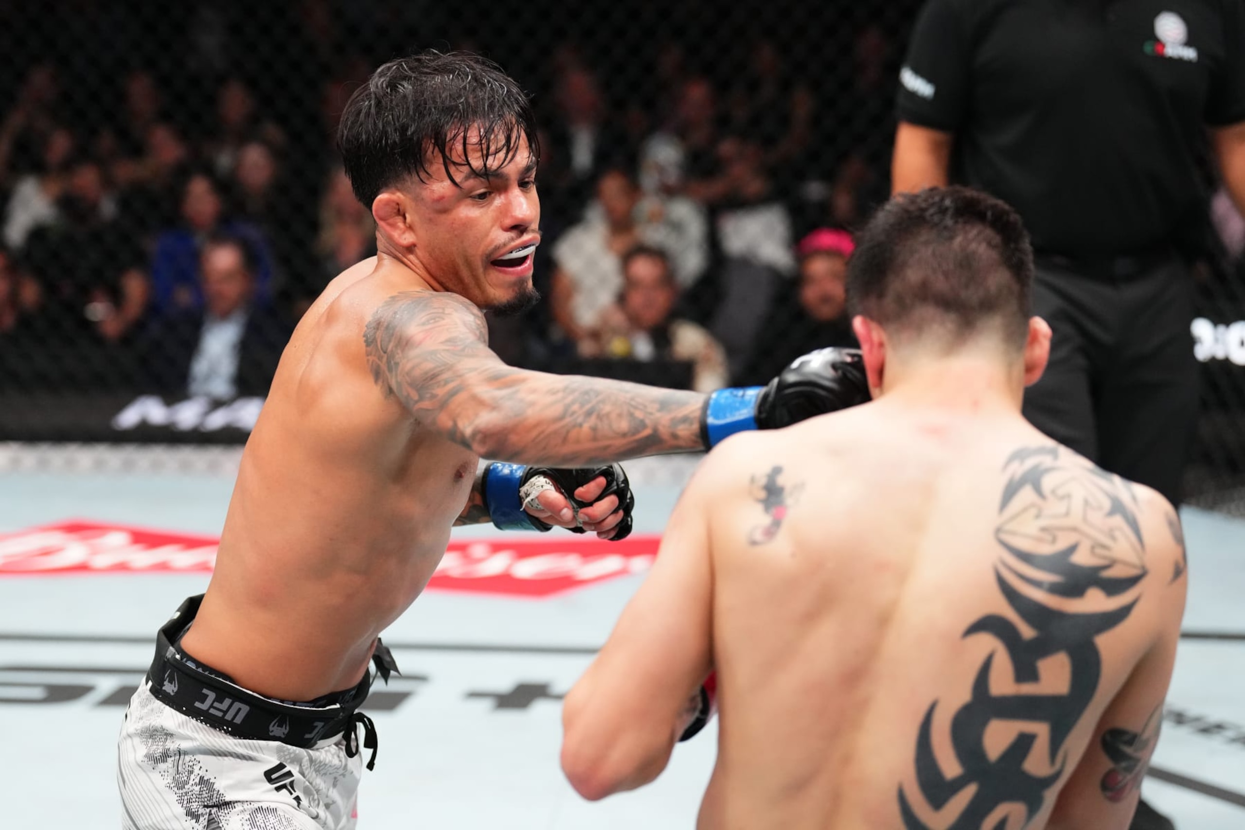 MEXICO CITY, MEXICO - FEBRUARY 24: (L-R) Brandon Royval punches Brandon Moreno of Mexico in a flyweight fight during the UFC Fight Night event at Arena CDMX on February 24, 2024 in Mexico City, Mexico. (Photo by Josh Hedges/Zuffa LLC via Getty Images)
