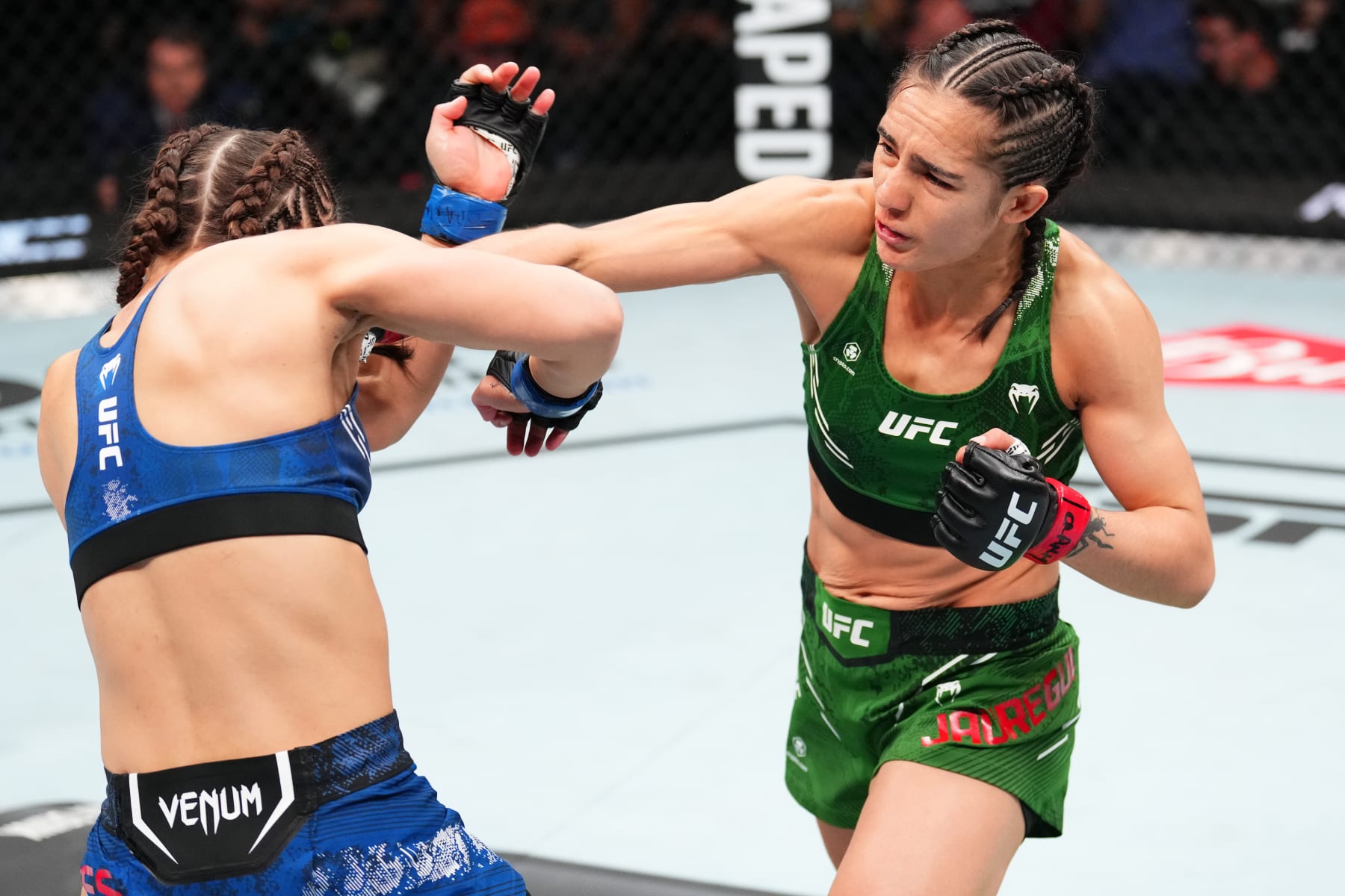 MEXICO CITY, MEXICO - FEBRUARY 24: Yazmin Jauregui of Mexico punches Sam Hughes in a strawweight fight during the UFC Fight Night event at Arena CDMX on February 24, 2024 in Mexico City, Mexico. (Photo by Josh Hedges/Zuffa LLC via Getty Images)