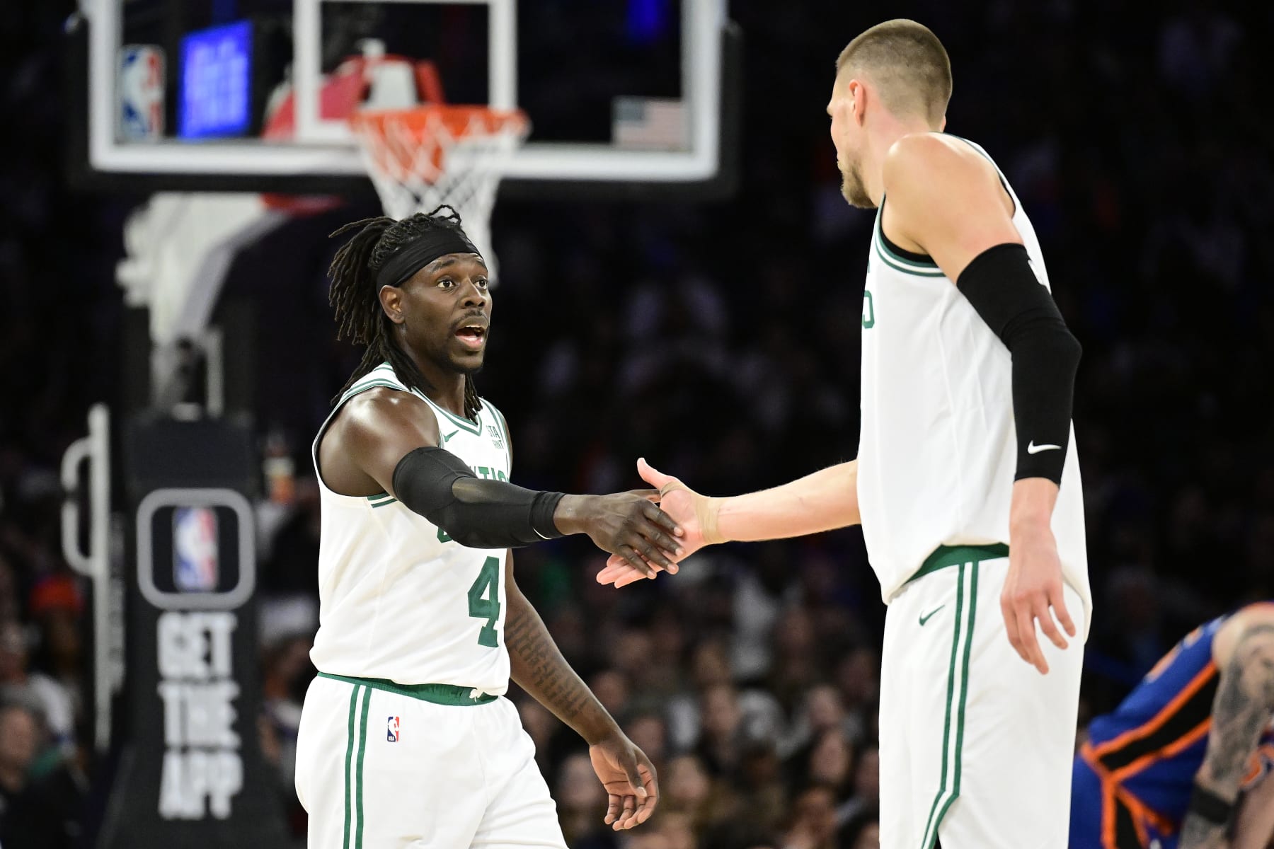 NEW YORK, NEW YORK - FEBRUARY 24:  Jrue Holiday #4 and Kristaps Porzingis #8 of the Boston Celtics celebrate a basket against the New York Knicks at Madison Square Garden on February 24, 2024 in New York City. NOTE TO USER: User expressly acknowledges and agrees that, by downloading and or using this photograph, User is consenting to the terms and conditions of the Getty Images License Agreement. (Photo by Steven Ryan/Getty Images)