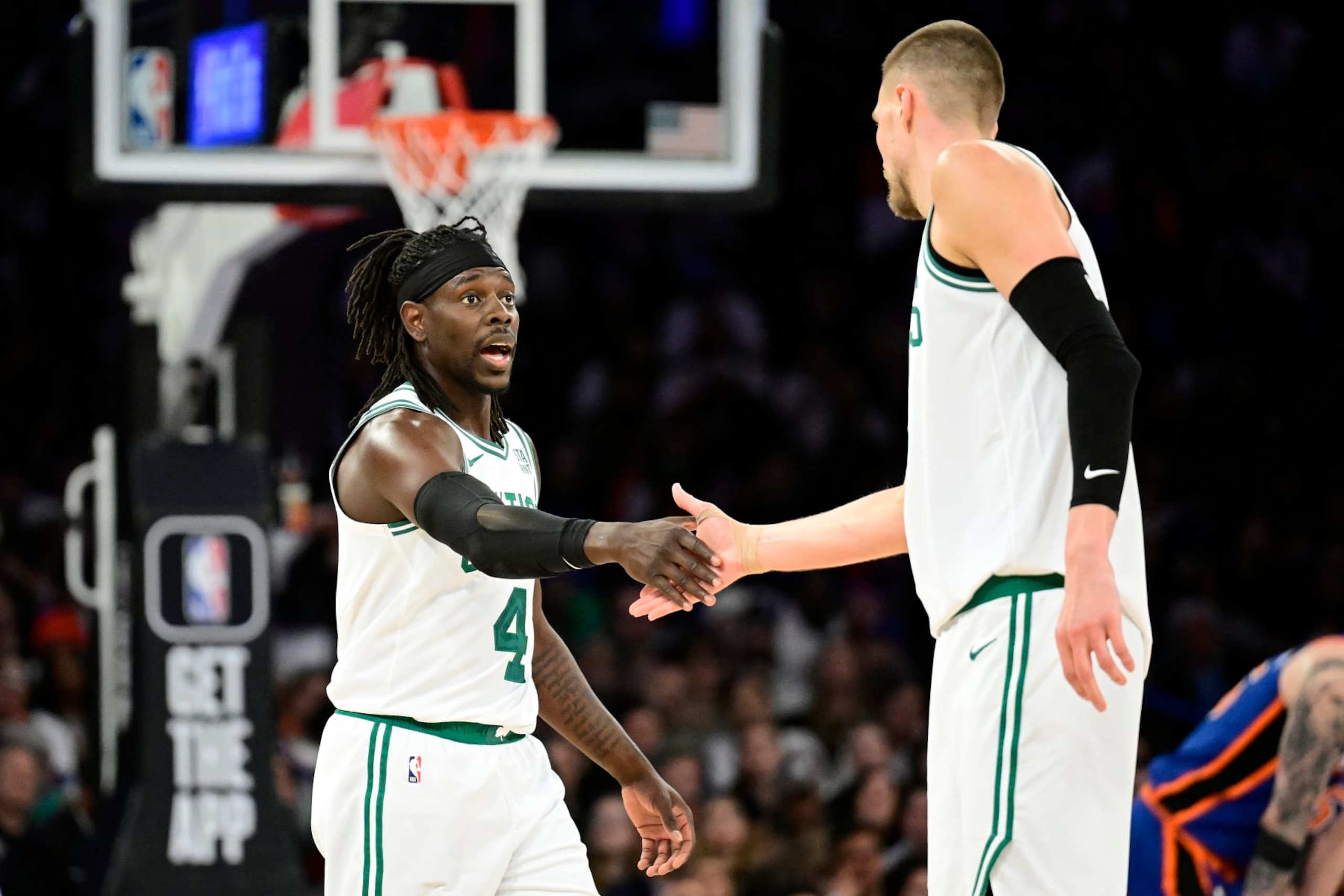 NEW YORK, NEW YORK - FEBRUARY 24:  Jrue Holiday #4 and Kristaps Porzingis #8 of the Boston Celtics celebrate a basket against the New York Knicks at Madison Square Garden on February 24, 2024 in New York City. NOTE TO USER: User expressly acknowledges and agrees that, by downloading and or using this photograph, User is consenting to the terms and conditions of the Getty Images License Agreement. (Photo by Steven Ryan/Getty Images)