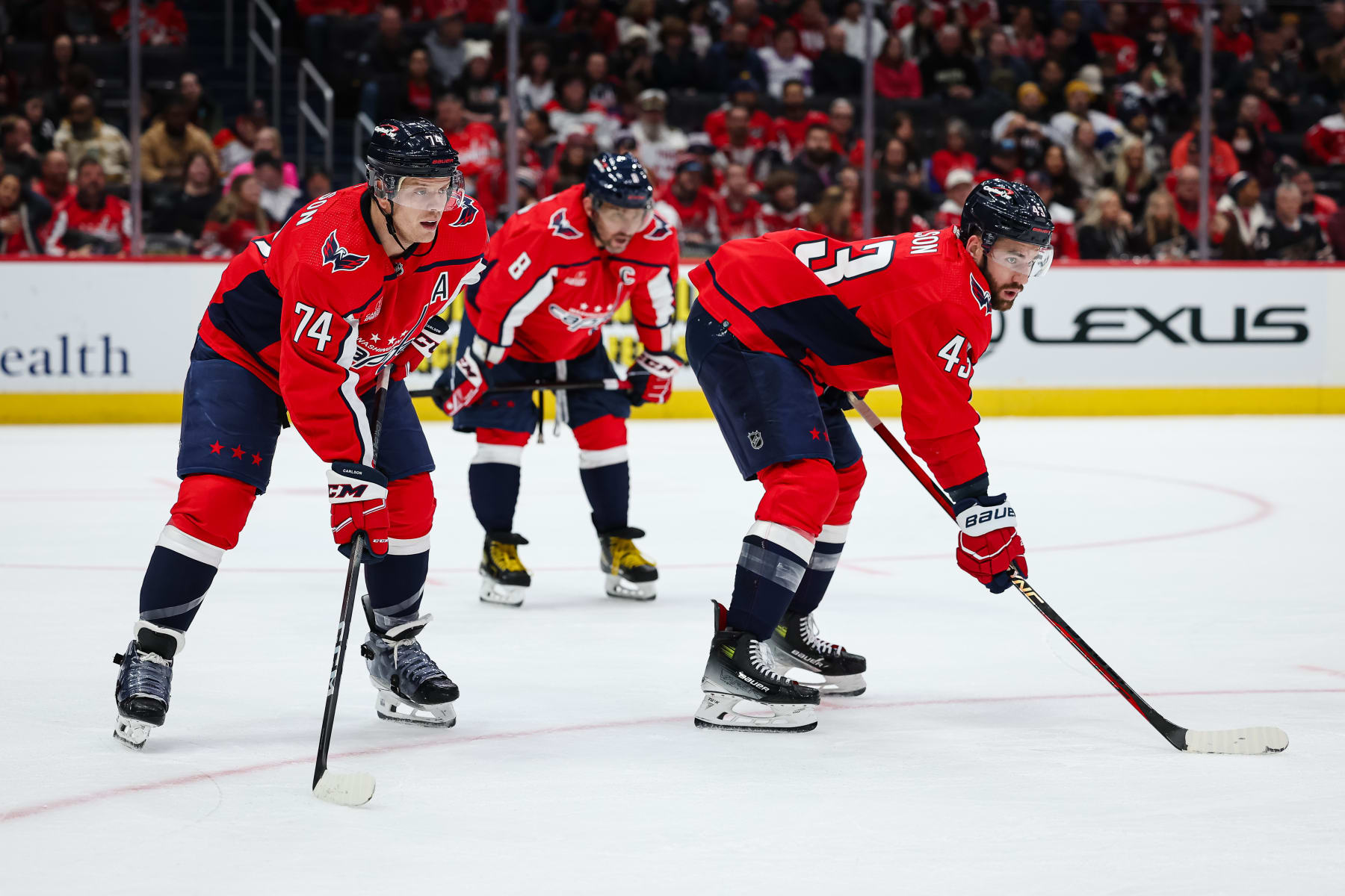 WASHINGTON, DC - JANUARY 03: John Carlson #74, Alex Ovechkin #8, and Tom Wilson #43 of the Washington Capitals line up against the New Jersey Devils during the first period of the game at Capital One Arena on January 3, 2024 in Washington, DC. (Photo by Scott Taetsch/Getty Images)