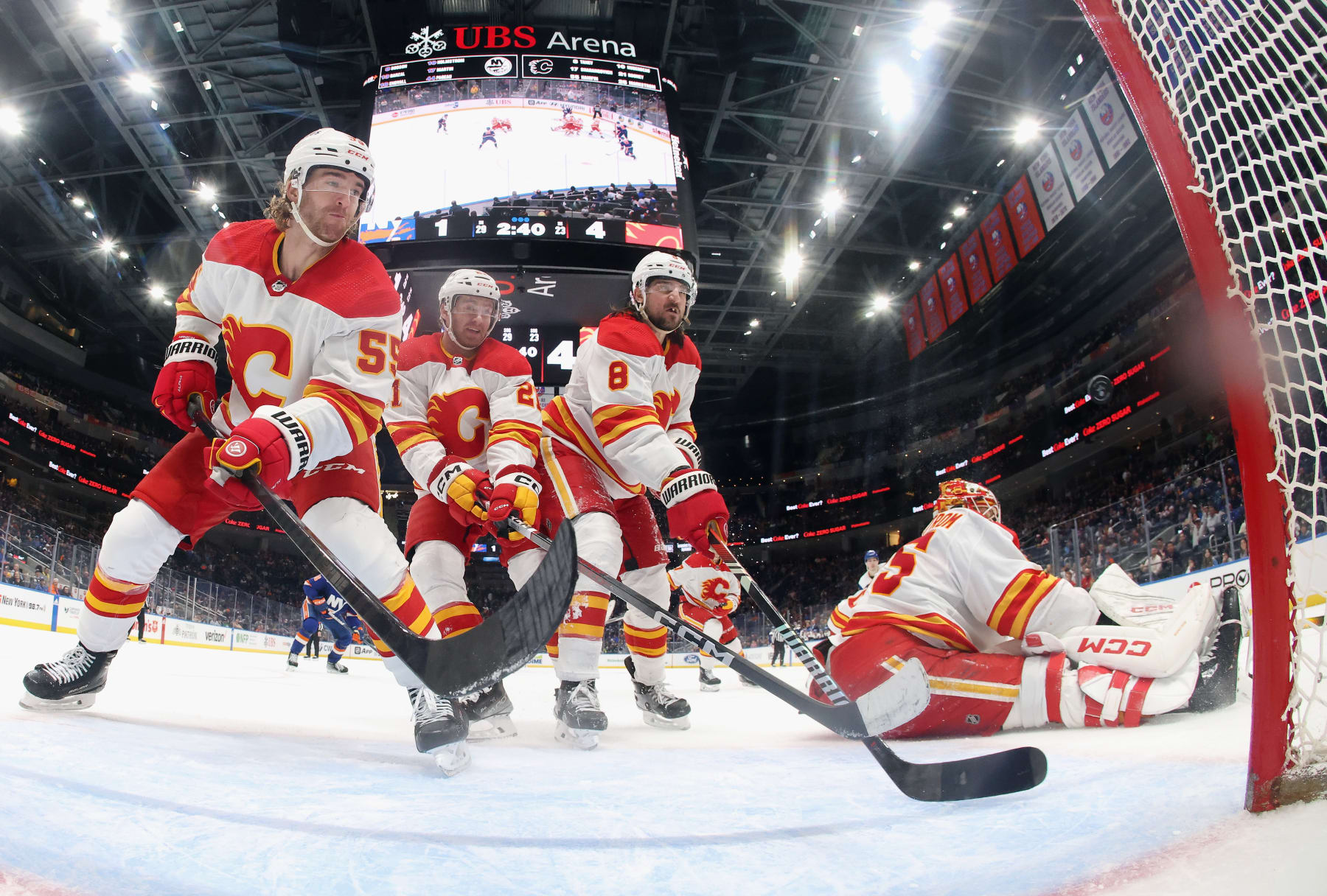 ELMONT, NEW YORK - FEBRUARY 10: (L-R) Noah Hanifin #55, Kevin Rooney #21, Chris Tanev #8 and Jacob Markstrom #35 of the Calgary Flames defend the net against the New York Islanders during the third period at UBS Arena on February 10, 2024 in Elmont, New York. The Flames defeated the Islanders 5-2. (Photo by Bruce Bennett/Getty Images)