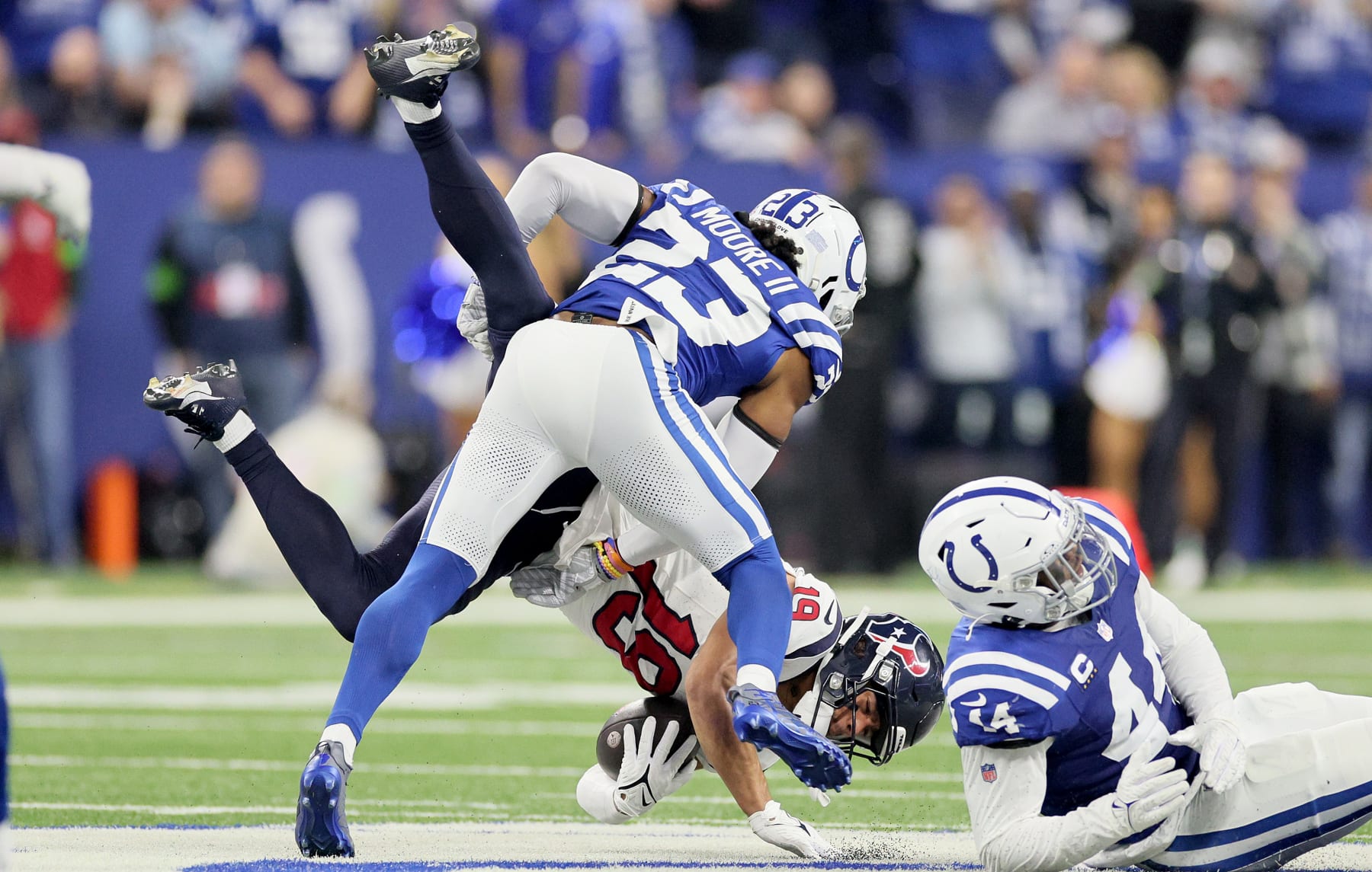 INDIANAPOLIS, INDIANA - JANUARY 06: Xavier Hutchinson #19 of the Houston Texans is tackled by Kenny Moore II #23 of the Indianapolis Colts at Lucas Oil Stadium on January 06, 2024 in Indianapolis, Indiana. (Photo by Andy Lyons/Getty Images)