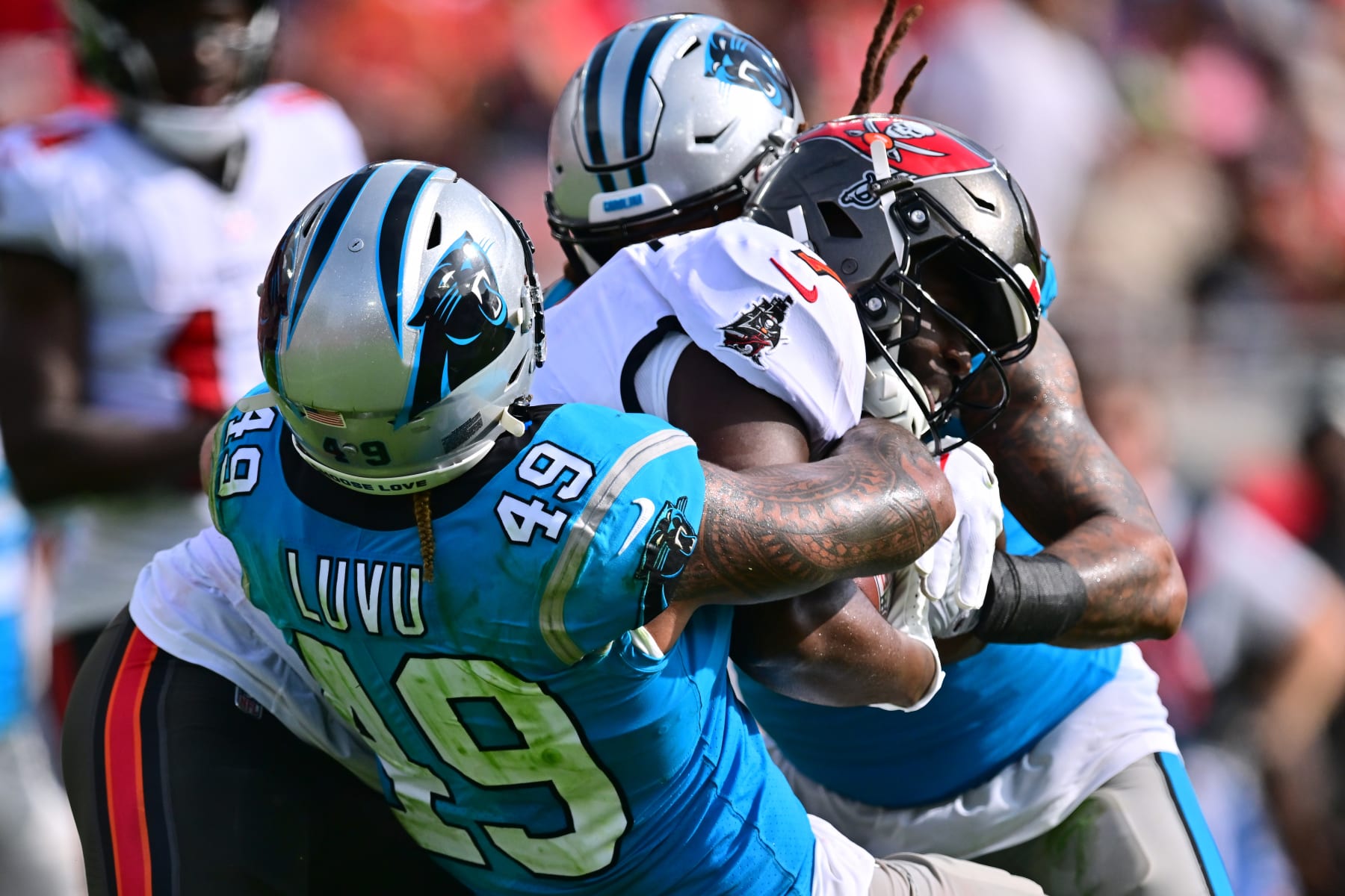 TAMPA, FLORIDA - JANUARY 01: Leonard Fournette #7 of the Tampa Bay Buccaneers is tackled by Frankie Luvu #49 of the Carolina Panthers during the second quarter at Raymond James Stadium on January 01, 2023 in Tampa, Florida. (Photo by Julio Aguilar/Getty Images)