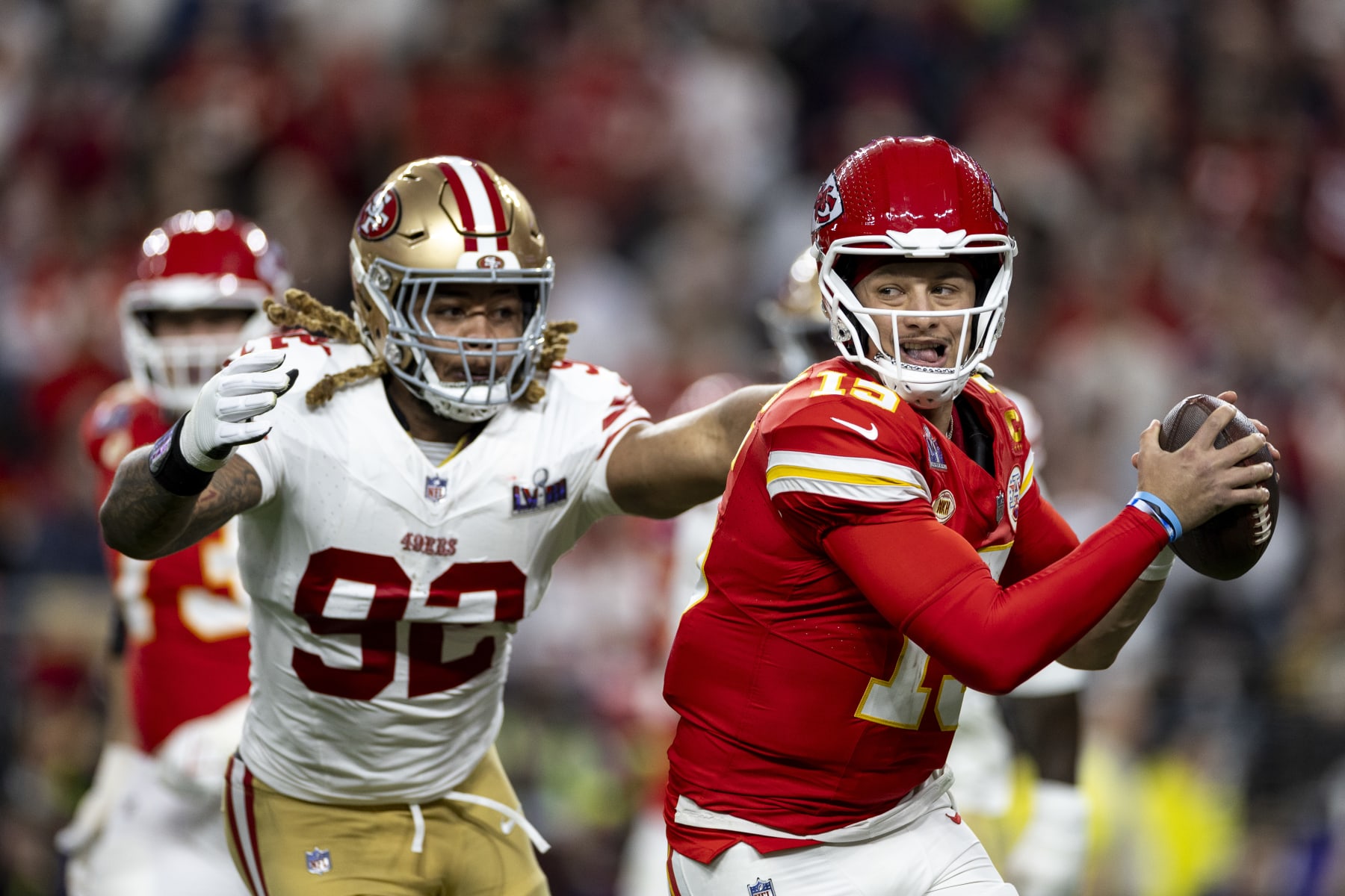 LAS VEGAS, NEVADA - FEBRUARY 11: Patrick Mahomes #15 of the Kansas City Chiefs scrambles and runs as he's tackled by Chase Young #92 of the San Francisco 49ers during the NFL Super Bowl 58 football game between the San Francisco 49ers and the Kansas City Chiefs at Allegiant Stadium on February 11, 2024 in Las Vegas, Nevada. (Photo by Michael Owens/Getty Images)