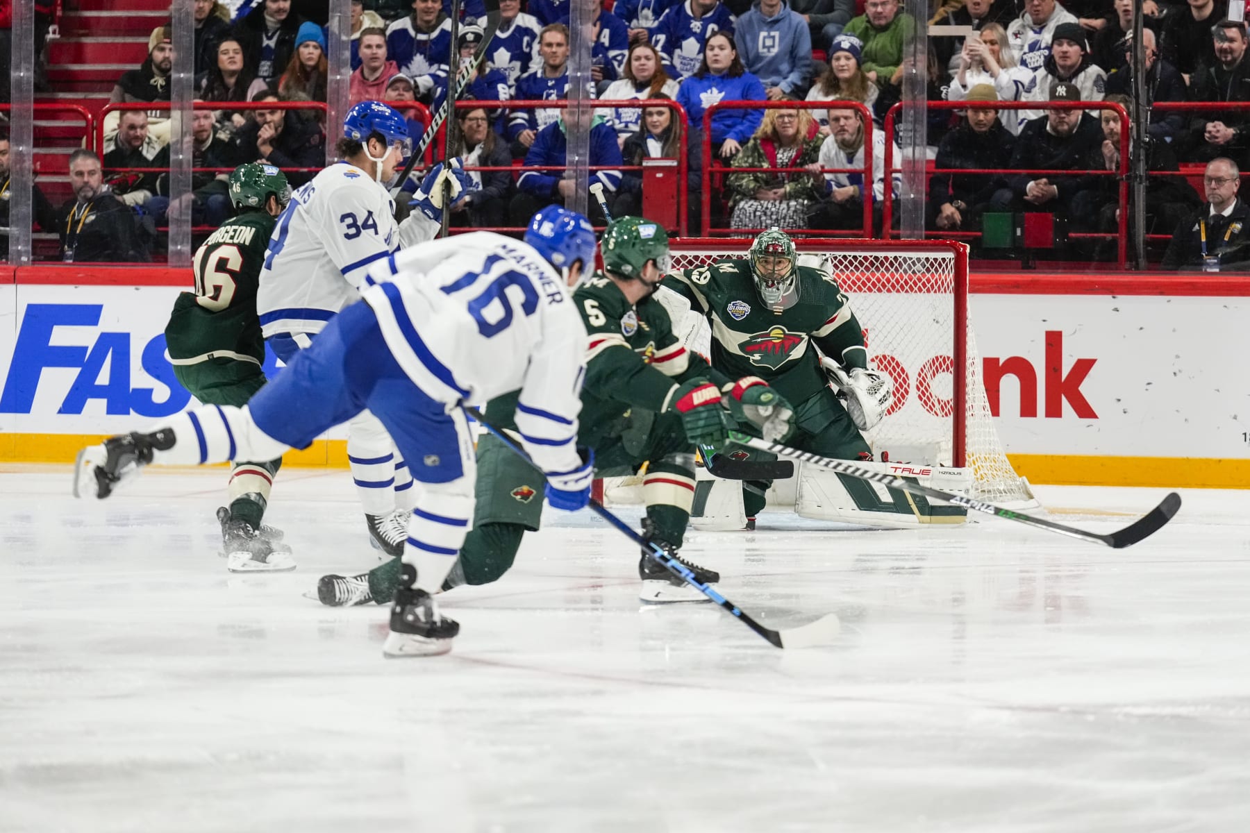 STOCKHOLM, SWEDEN - NOVEMBER 19: Marc-Andre Fleury #29 of the Minnesota Wild watches as Mitchell Marner #16 of the Toronto Maple Leafs plays the puck  during the first period during the 2023 NHL Global Series Sweden at Avicii Arena on November 19, 2023 in Stockholm, Sweden. (Photo by Mark Blinch/NHLI via Getty Images)