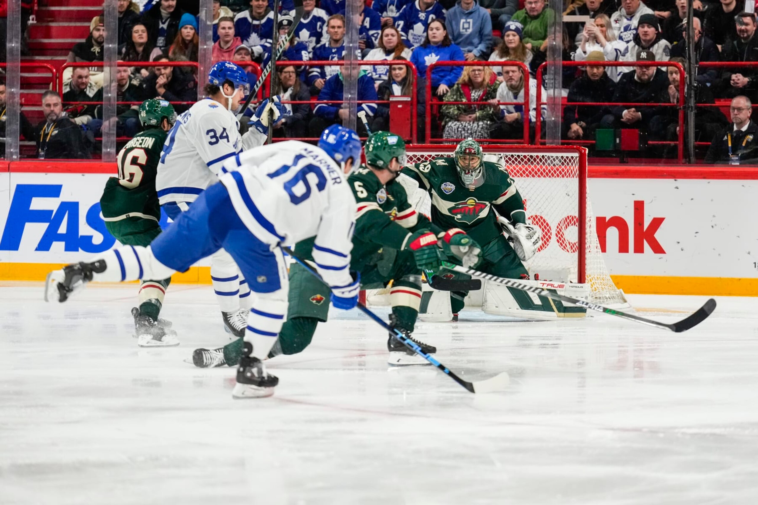 STOCKHOLM, SWEDEN - NOVEMBER 19: Marc-Andre Fleury #29 of the Minnesota Wild watches as Mitchell Marner #16 of the Toronto Maple Leafs plays the puck  during the first period during the 2023 NHL Global Series Sweden at Avicii Arena on November 19, 2023 in Stockholm, Sweden. (Photo by Mark Blinch/NHLI via Getty Images)