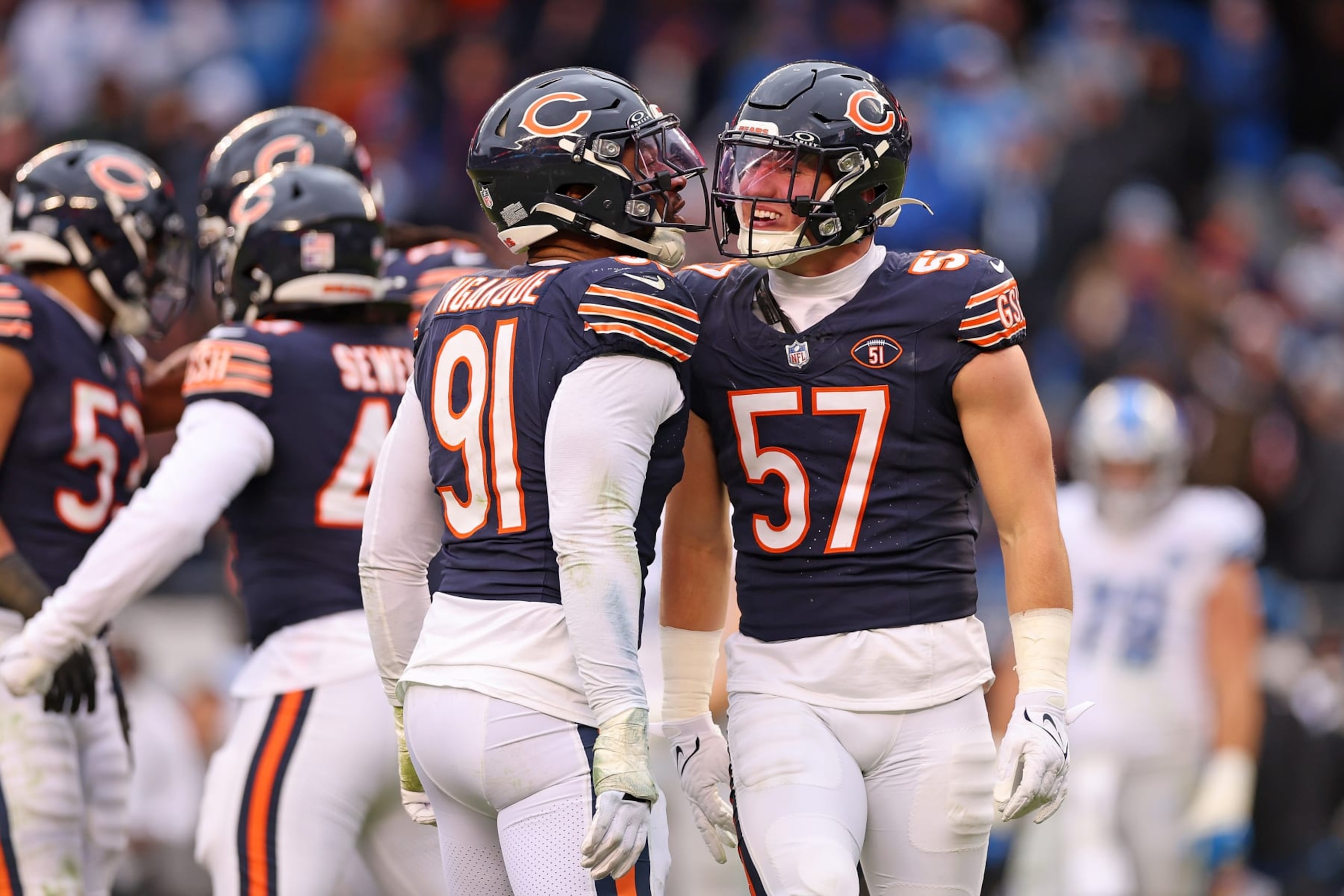CHICAGO, ILLINOIS - DECEMBER 10: Yannick Ngakoue #91 and Jack Sanborn #57 of the Chicago Bears celebrate a defensive stop during the fourth quarter in the game against the Detroit Lions at Soldier Field on December 10, 2023 in Chicago, Illinois. (Photo by Michael Reaves/Getty Images)