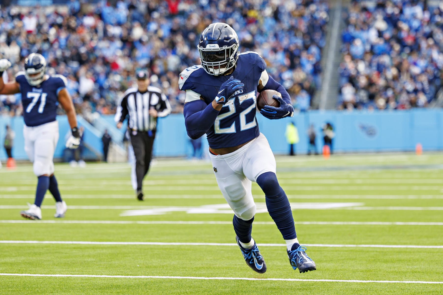 NASHVILLE TENNESSEE - JANUARY 07: Derrick Henry #22 of the Tennessee Titans runs the ball for a touchdown during the game against the Jacksonville Jaguars in Nashville, Tennessee at Nissan Stadium on January 7, 2024 in Houston, Texas. The Titans defeated the Jaguars 28-20.  (Photo by Wesley Hitt/Getty Images)