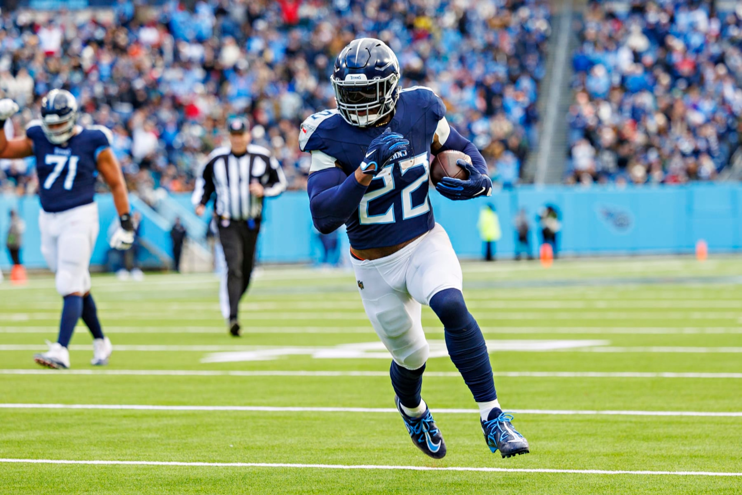 NASHVILLE TENNESSEE - JANUARY 07: Derrick Henry #22 of the Tennessee Titans runs the ball for a touchdown during the game against the Jacksonville Jaguars in Nashville, Tennessee at Nissan Stadium on January 7, 2024 in Houston, Texas. The Titans defeated the Jaguars 28-20.  (Photo by Wesley Hitt/Getty Images)