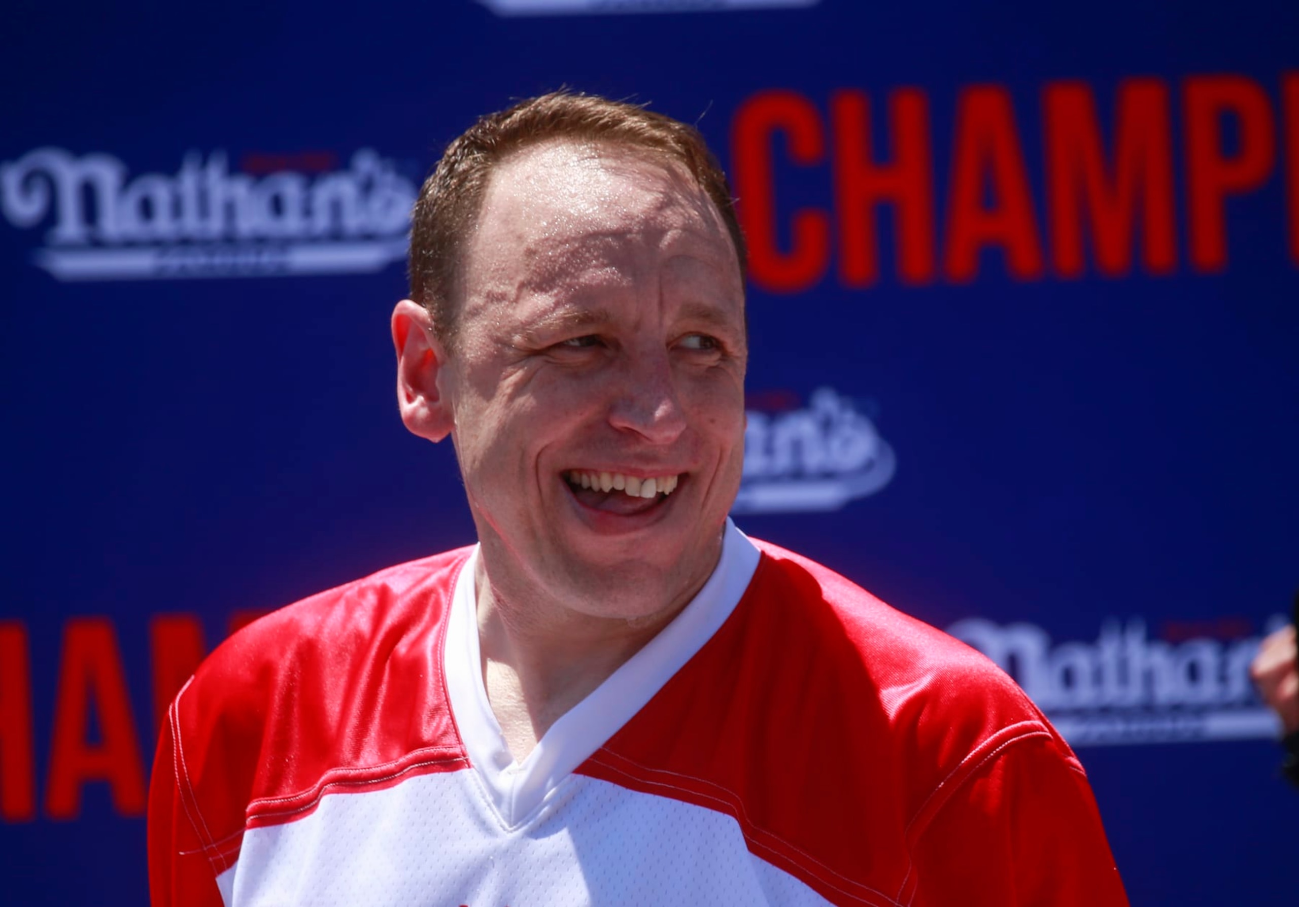 NEW YORK, NY - JULY 04: Joey Chestnut reacts after he won first place, eating 63 hot dogs in 10 minutes, during the 2022 Nathan's Famous Fourth of July International Hot Dog Eating Contest on July 4, 2022 at Coney Island in the Brooklyn borough of New York City. The contest, which has happened every year since 1972, has returned in front of Nathan's Famous on Surf Avenue this year. (Photo by Kena Betancur/Getty Images)