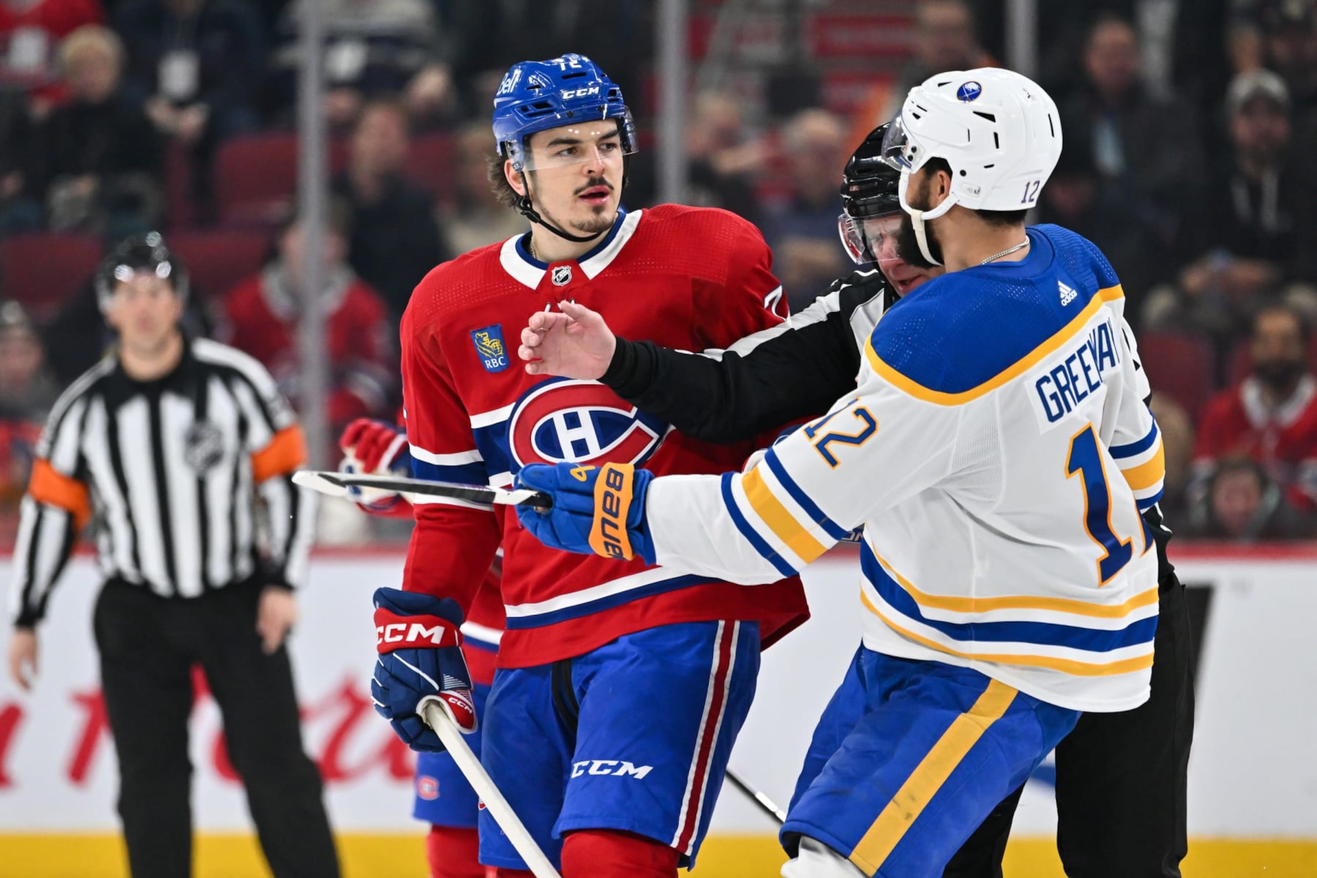 MONTREAL, CANADA - FEBRUARY 21:  Arber Xhekaj #72 of the Montreal Canadiens and Jordan Greenway #12 of the Buffalo Sabres stare each other down during the second period at the Bell Centre on February 21, 2024 in Montreal, Quebec, Canada.  (Photo by Minas Panagiotakis/Getty Images)