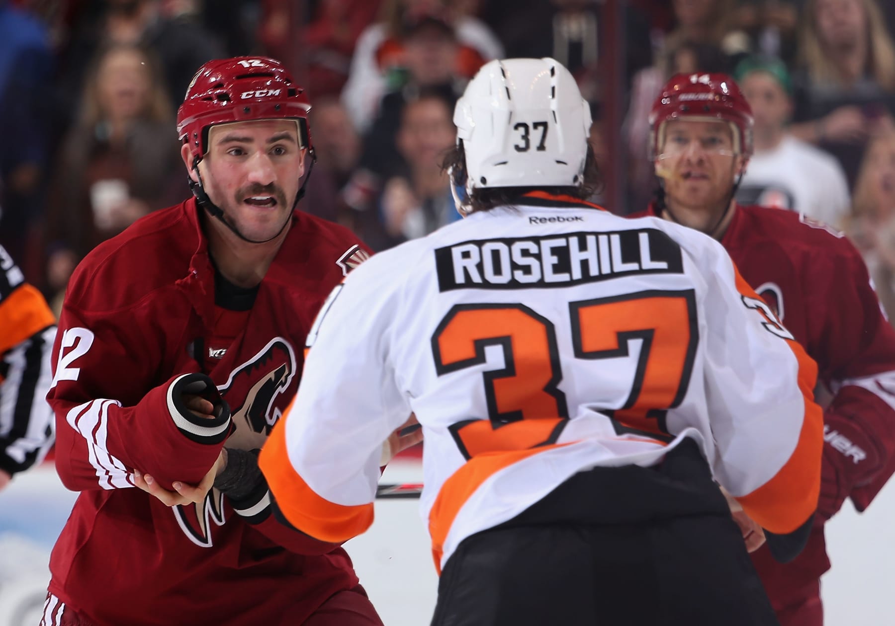 GLENDALE, AZ - JANUARY 04:  Paul Bissonnette #12 of the Phoenix Coyotes fights with Jay Rosehill #37 of the Philadelphia Flyers during the second period of the NHL game at Jobing.com Arena on January 4, 2014 in Glendale, Arizona.  (Photo by Christian Petersen/Getty Images)