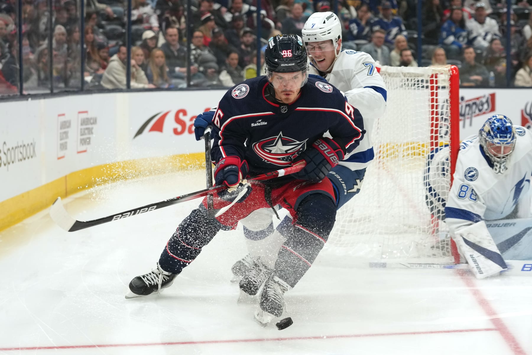 COLUMBUS, OHIO - FEBRUARY 10: Jack Roslovic #96 of the Columbus Blue Jackets battle Haydn Fleury #7 of the Tampa Bay Lightning for the puck during the second period at Nationwide Arena on February 10, 2024 in Columbus, Ohio. (Photo by Jason Mowry/Getty Images)