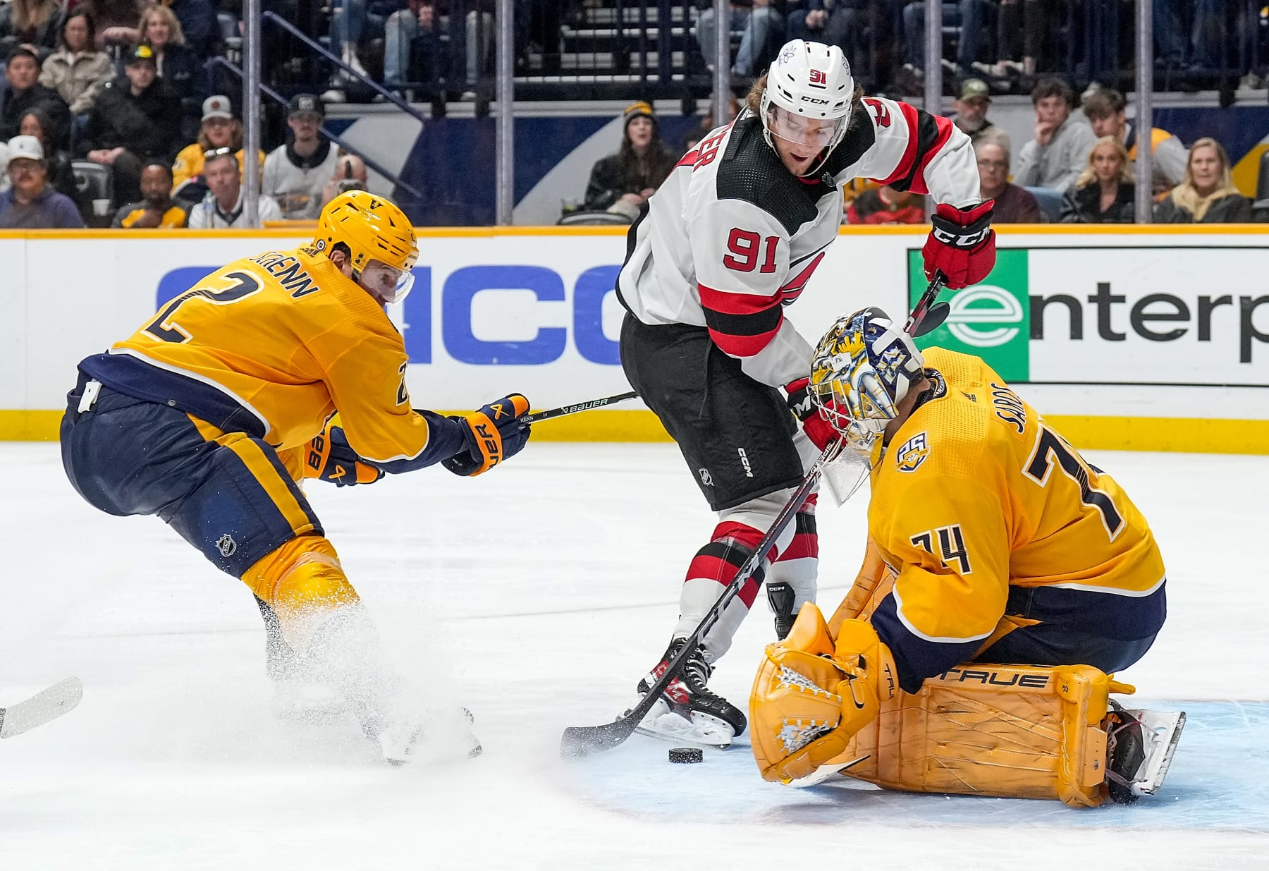 NASHVILLE, TENNESSEE - FEBRUARY 13: Juuse Saros #74 of the Nashville Predators makes a save against Dawson Mercer #91 of the New Jersey Devils during an NHL game at Bridgestone Arena on February 13, 2024 in Nashville, Tennessee. (Photo by John Russell/NHLI via Getty Images)
