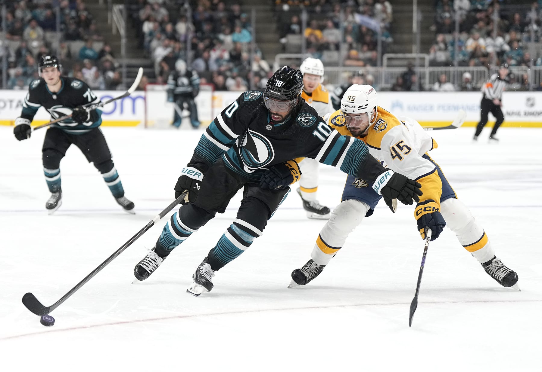 SAN JOSE, CALIFORNIA - FEBRUARY 24: Anthony Duclair #10 of the San Jose Sharks skates with the puck defended by Alexandre Carrier #45 of the Nashville Predators during the second period period of an NHL hockey game at SAP Center on February 24, 2024 in San Jose, California. (Photo by Thearon W. Henderson/Getty Images)