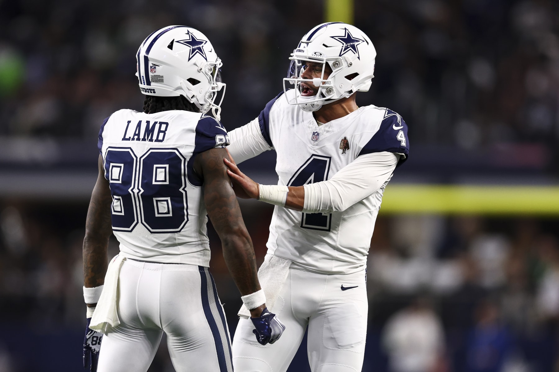 ARLINGTON, TX - DECEMBER 10: Dak Prescott #4 of the Dallas Cowboys celebrates with CeeDee Lamb #88 after scoring a touchdown during the first quarter against the Philadelphia Eagles at AT&T Stadium on December 10, 2023 in Arlington, Texas. (Photo by Kevin Sabitus/Getty Images)