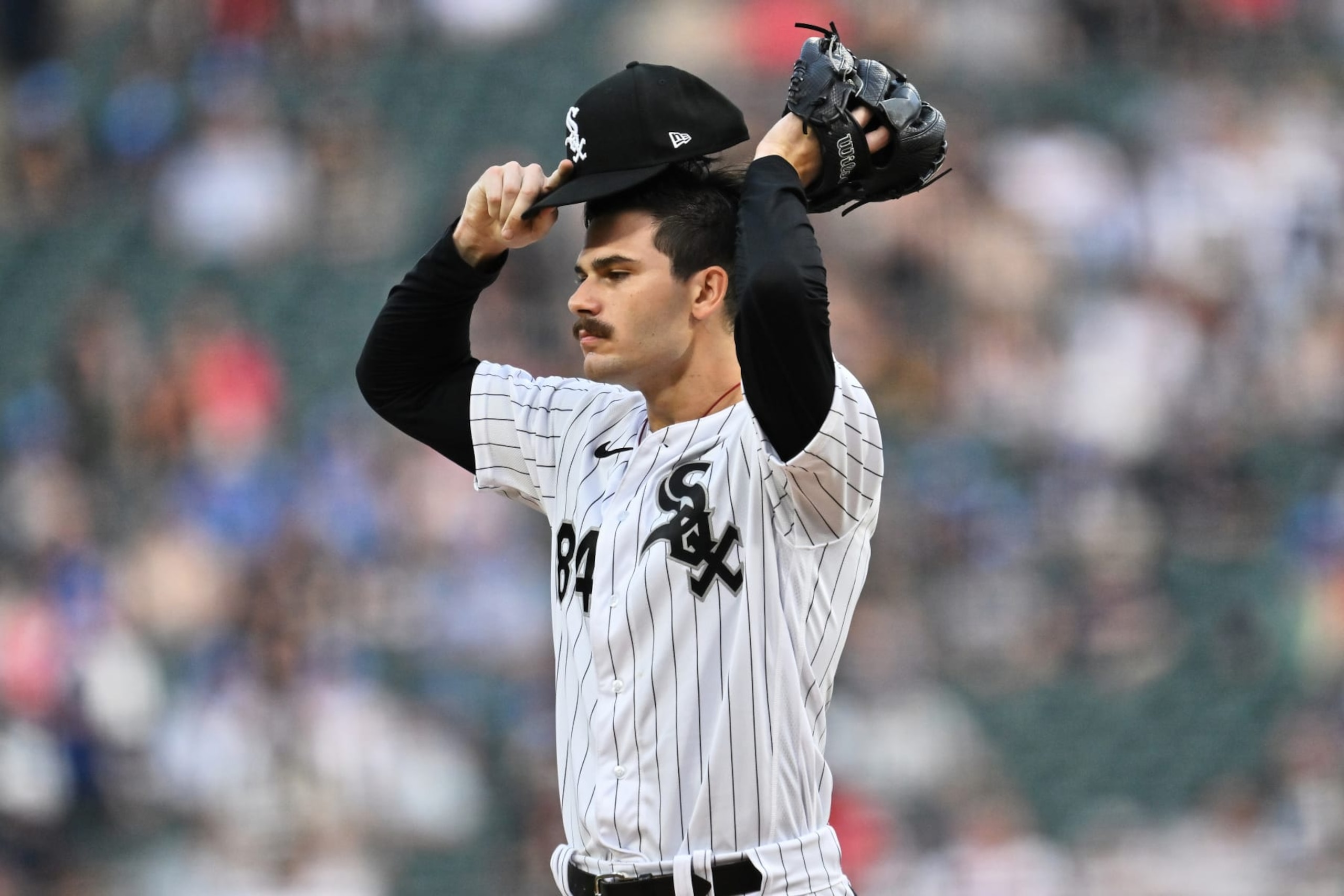 CHICAGO, IL - JULY 27:  Dylan Cease #84 of the Chicago White Sox adjusts his cap while pitching against the Cleveland Guardians at Guaranteed Rate Field on July 27, 2023 in Chicago, Illinois.  (Photo by Jamie Sabau/Getty Images)