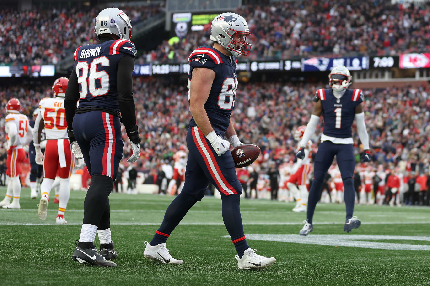 FOXBOROUGH, MASSACHUSETTS - DECEMBER 17: Pharaoh Brown #86 and Hunter Henry #85 of the New England Patriots celebrate after Henry's receiving touchdown during the second quarter against the Kansas City Chiefs at Gillette Stadium on December 17, 2023 in Foxborough, Massachusetts. (Photo by Maddie Meyer/Getty Images)