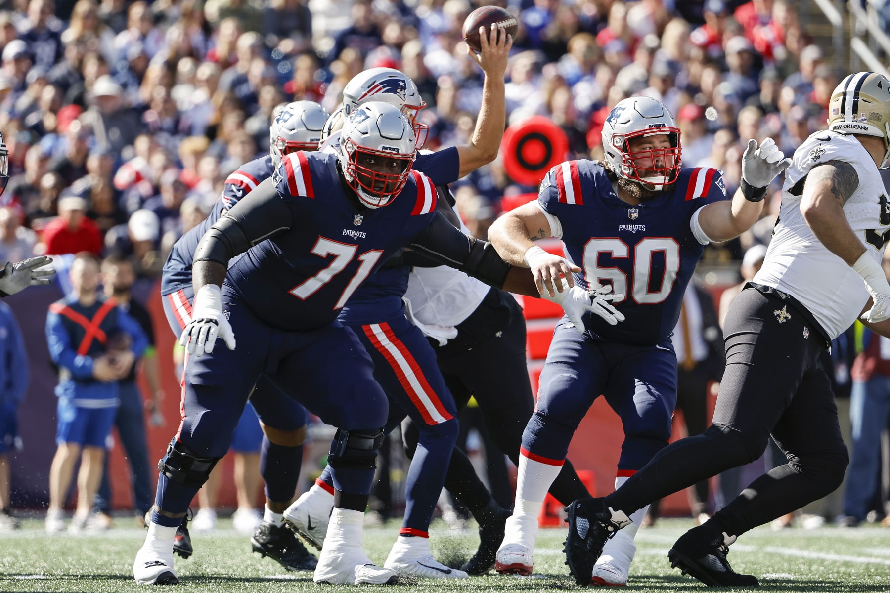 FOXBOROUGH, MA - OCTOBER 8: Mike Onwenu #71 of the New England Patriots and David Andrews #60 block against the New Orleans Saints during the game at Gillette Stadium on October 8, 2023 in Foxborough, Massachusetts.(Photo By Winslow Townson/Getty Images)