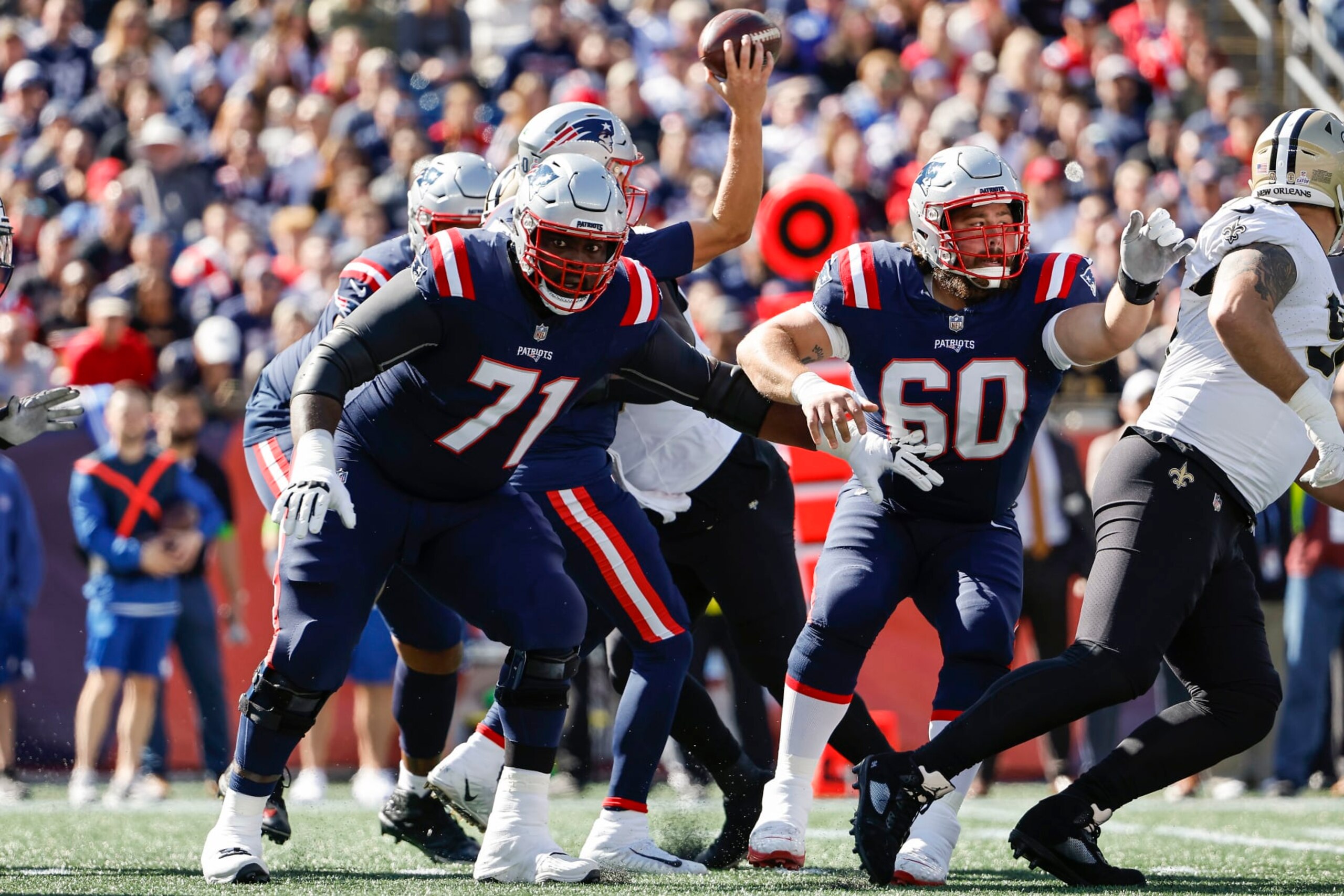FOXBOROUGH, MA - OCTOBER 8: Mike Onwenu #71 of the New England Patriots and David Andrews #60 block against the New Orleans Saints during the game at Gillette Stadium on October 8, 2023 in Foxborough, Massachusetts.(Photo By Winslow Townson/Getty Images)