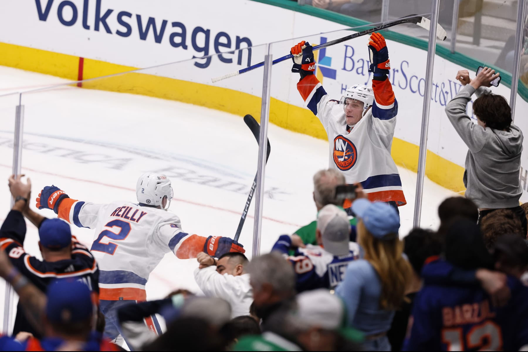 DALLAS, TEXAS - FEBRUARY 26: Bo Horvat #14 of the New York Islanders celebrates with Mike Reilly #2 after scoring the game winning goal in overtime to defeat the Dallas Stars at American Airlines Center on February 26, 2024 in Dallas, Texas. (Photo by Sam Hodde/Getty Images)