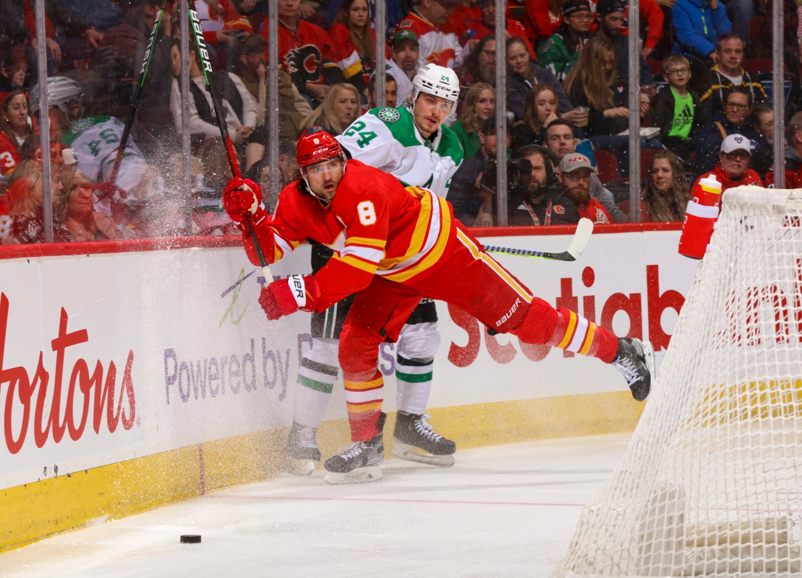 CALGARY, ALBERTA - MARCH 18: Chris Tanev #8 of the Calgary Flames checks Roope Hintz #24 of the Dallas Stars at Scotiabank Saddledome on March 18, 2023 in Calgary, Alberta. (Photo by Gerry Thomas/NHLI via Getty Images) CALGARY, ALBERTA - MARCH 18: Chris Tanev #8 of the Calgary Flames checks Roope Hintz #24 of the Dallas Stars at Scotiabank Saddledome on March 18, 2023 in Calgary, Alberta. (Photo by Gerry Thomas/NHLI via Getty Images)