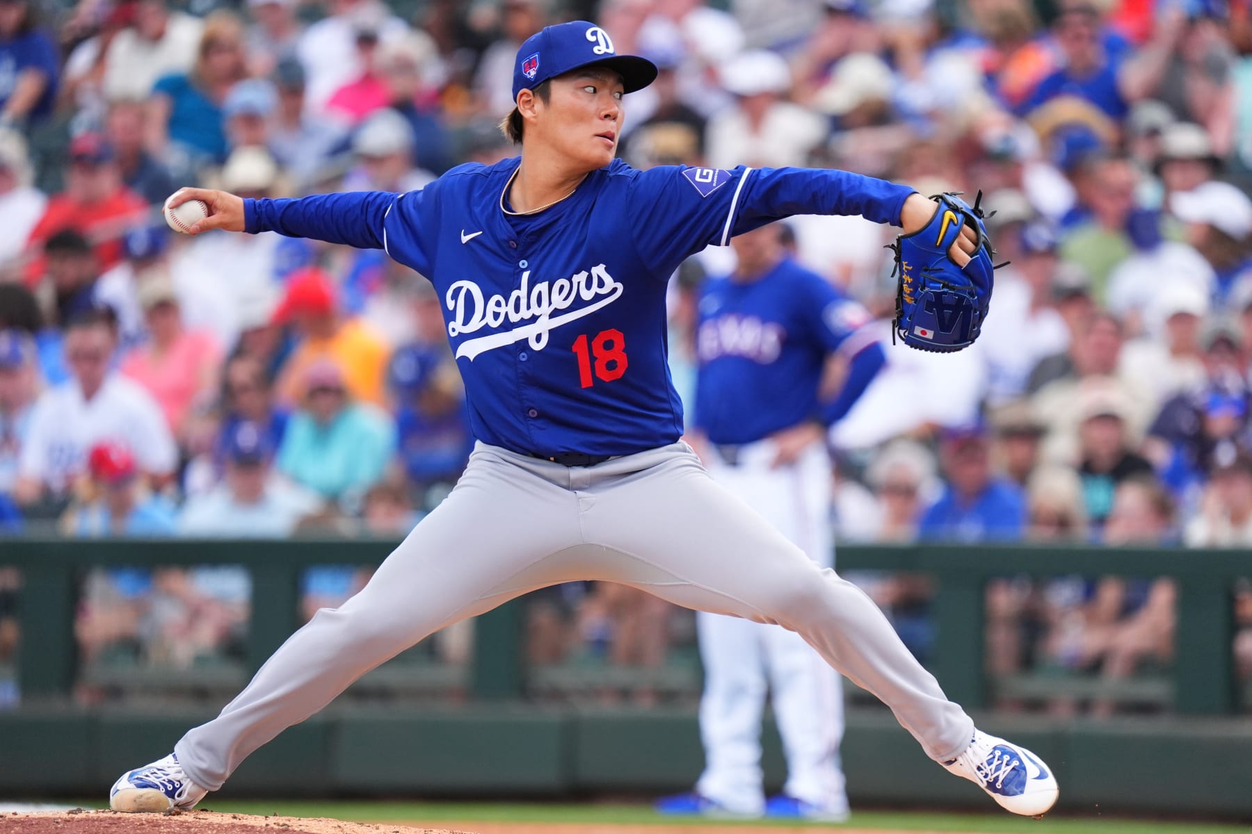 SURPRISE, ARIZONA - FEBRUARY 28: Yoshinobu Yamamoto #18 of the  Los Angeles Dodgers pitches during a game against the Texas Rangers at Surprise Stadium on February 28, 2024 in Surprise, Arizona. (Photo by Masterpress/Getty Images)