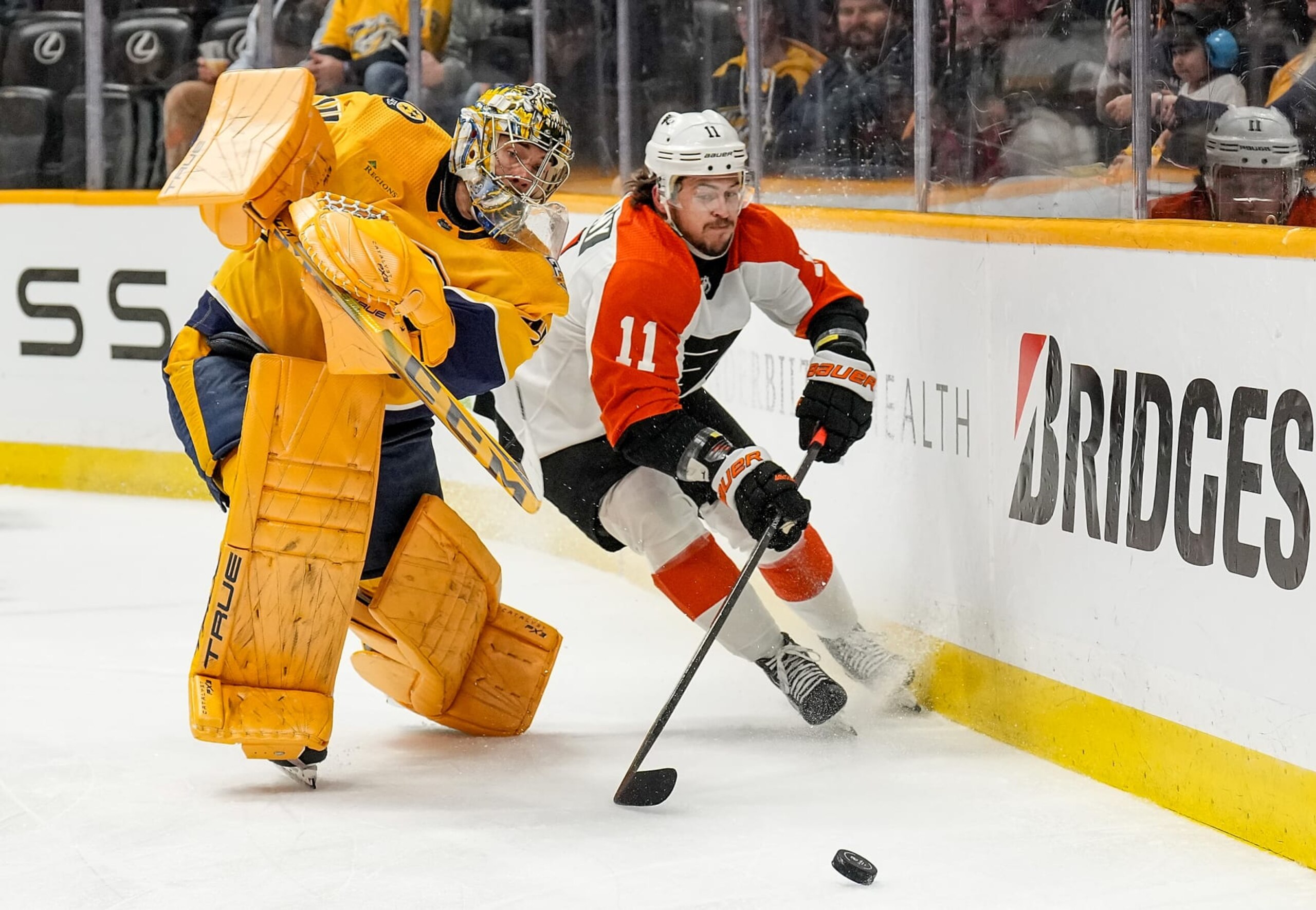 NASHVILLE, TENNESSEE - DECEMBER 12: Juuse Saros #74 of the Nashville Predators clears the puck against Travis Konecny #11 of the Philadelphia Flyers during an NHL game at Bridgestone Arena on December 12, 2023 in Nashville, Tennessee. (Photo by John Russell/NHLI via Getty Images) NASHVILLE, TENNESSEE - DECEMBER 12: Juuse Saros #74 of the Nashville Predators clears the puck against Travis Konecny #11 of the Philadelphia Flyers during an NHL game at Bridgestone Arena on December 12, 2023 in Nashville, Tennessee. (Photo by John Russell/NHLI via Getty Images)