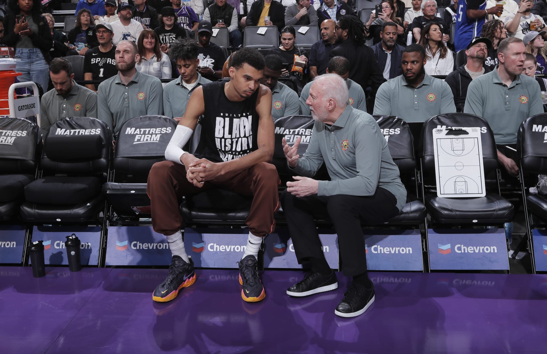 SACRAMENTO, CA - FEBRUARY 22: Head Coach Gregg Popovich of the San Antonio Spurs coaches Victor Wembanyama #1 prior to the game against the Sacramento Kings on February 22, 2024 at Golden 1 Center in Sacramento, California. NOTE TO USER: User expressly acknowledges and agrees that, by downloading and or using this photograph, User is consenting to the terms and conditions of the Getty Images Agreement. Mandatory Copyright Notice: Copyright 2024 NBAE (Photo by Rocky Widner/NBAE via Getty Images)