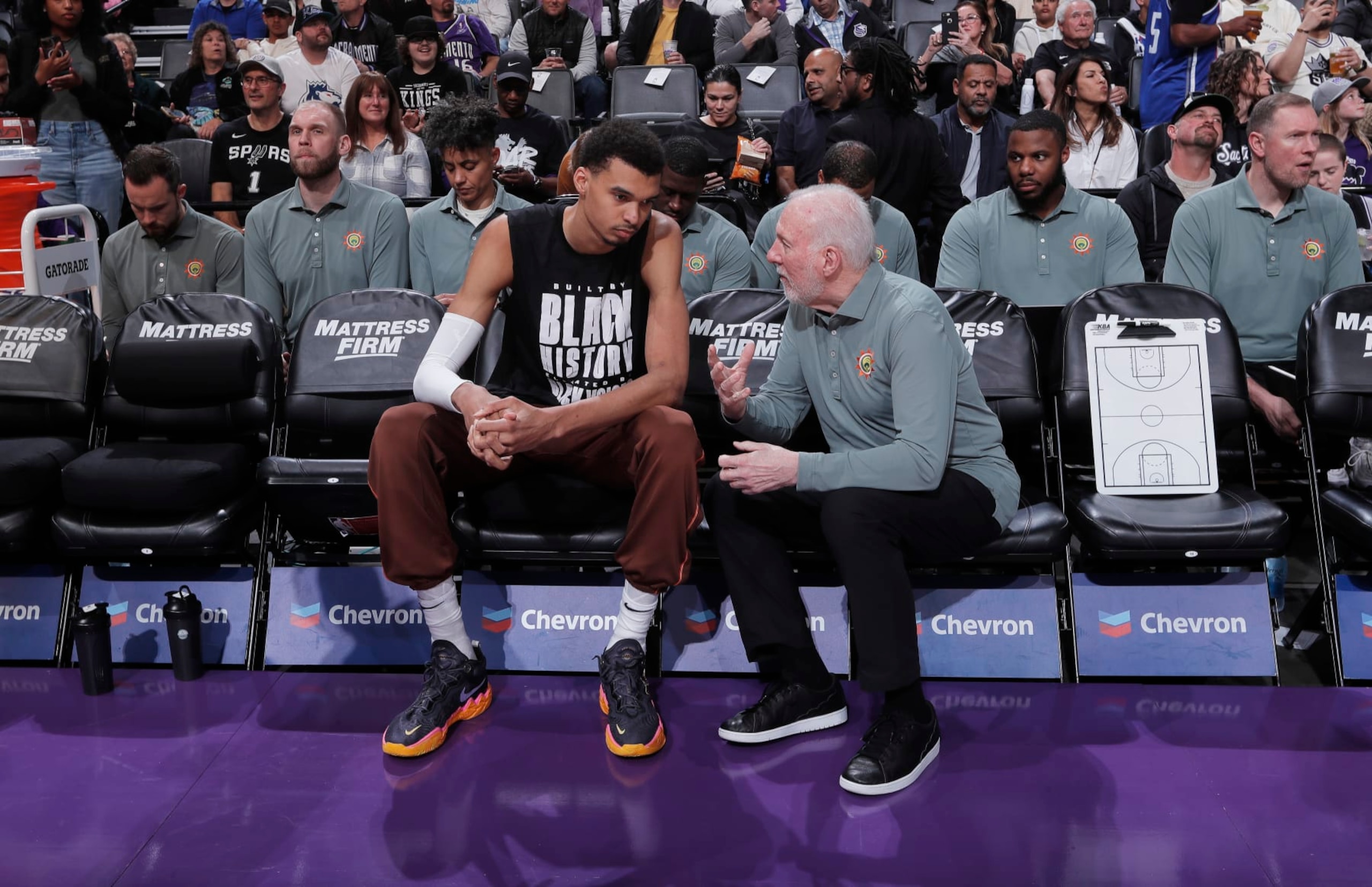 SACRAMENTO, CA - FEBRUARY 22: Head Coach Gregg Popovich of the San Antonio Spurs coaches Victor Wembanyama #1 prior to the game against the Sacramento Kings on February 22, 2024 at Golden 1 Center in Sacramento, California. NOTE TO USER: User expressly acknowledges and agrees that, by downloading and or using this photograph, User is consenting to the terms and conditions of the Getty Images Agreement. Mandatory Copyright Notice: Copyright 2024 NBAE (Photo by Rocky Widner/NBAE via Getty Images)
