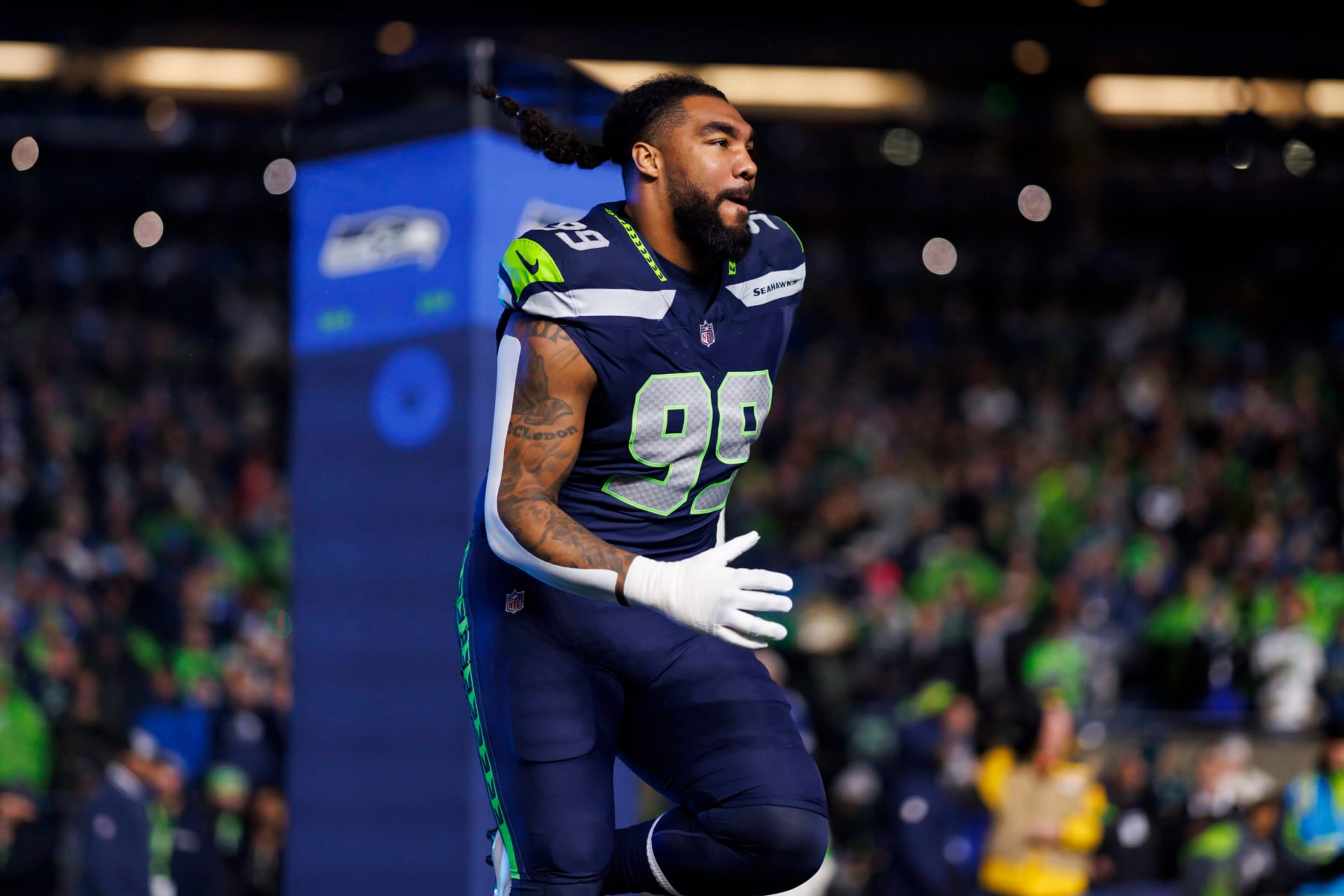 SEATTLE, WASHINGTON - DECEMBER 18: Leonard Williams #99 of the Seattle Seahawks runs onto the field during player introductions before an NFL football game against the Philadelphia Eagles at Lumen Field on December 18, 2023 in Seattle, Washington. (Photo by Ryan Kang/Getty Images)
