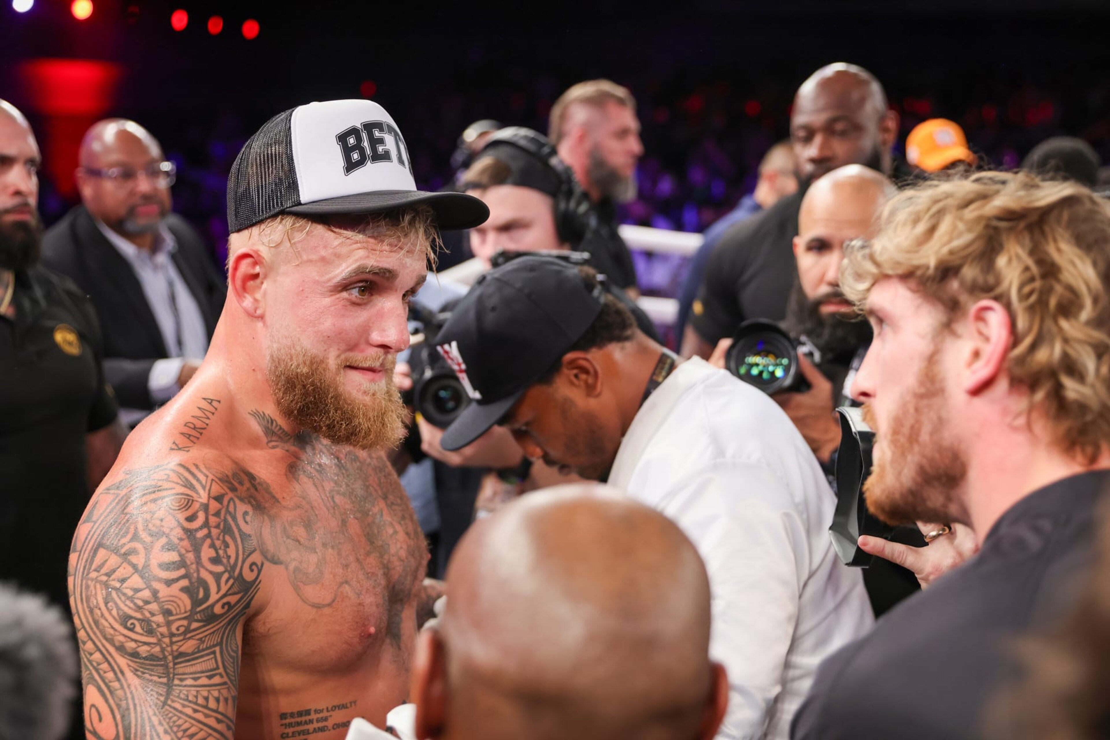 ORLANDO, FL - DECEMBER 15: Jake Paul speaks with Logan Paul after knocking out Andre August in the first round during the Jake Paul v Andre August at the Caribe Royale Orlando on December 15 2023 in Orlando, Florida. (Photo by Alex Menendez/Getty Images)