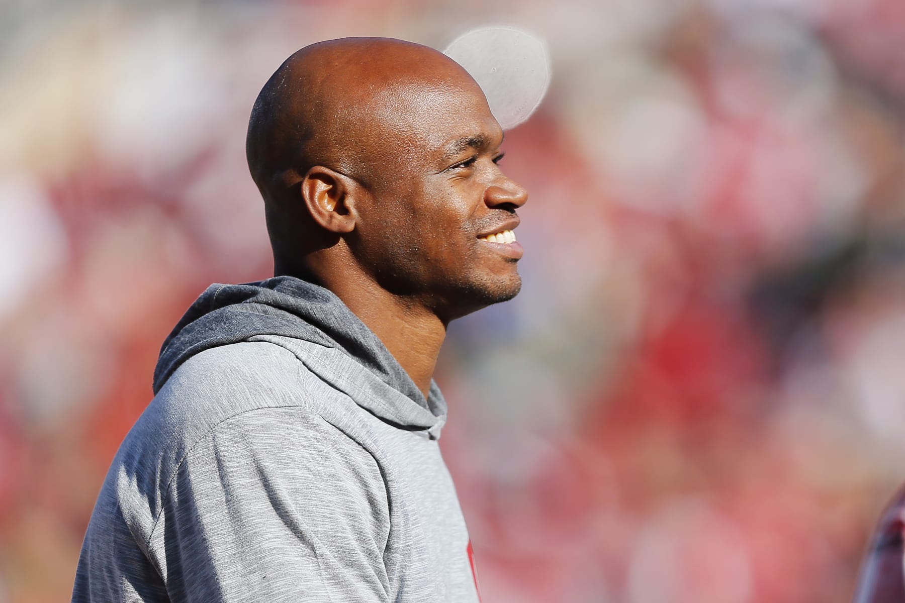 NORMAN, OKLAHOMA - NOVEMBER 24:  Running back Adrian Peterson smiles as he is recognized during a game between the Oklahoma Sooners and the TCU Horned Frogs at Gaylord Family Oklahoma Memorial Stadium on November 24, 2023 in Norman, Oklahoma.  Oklahoma won 69-45. (Photo by Brian Bahr/Getty Images)