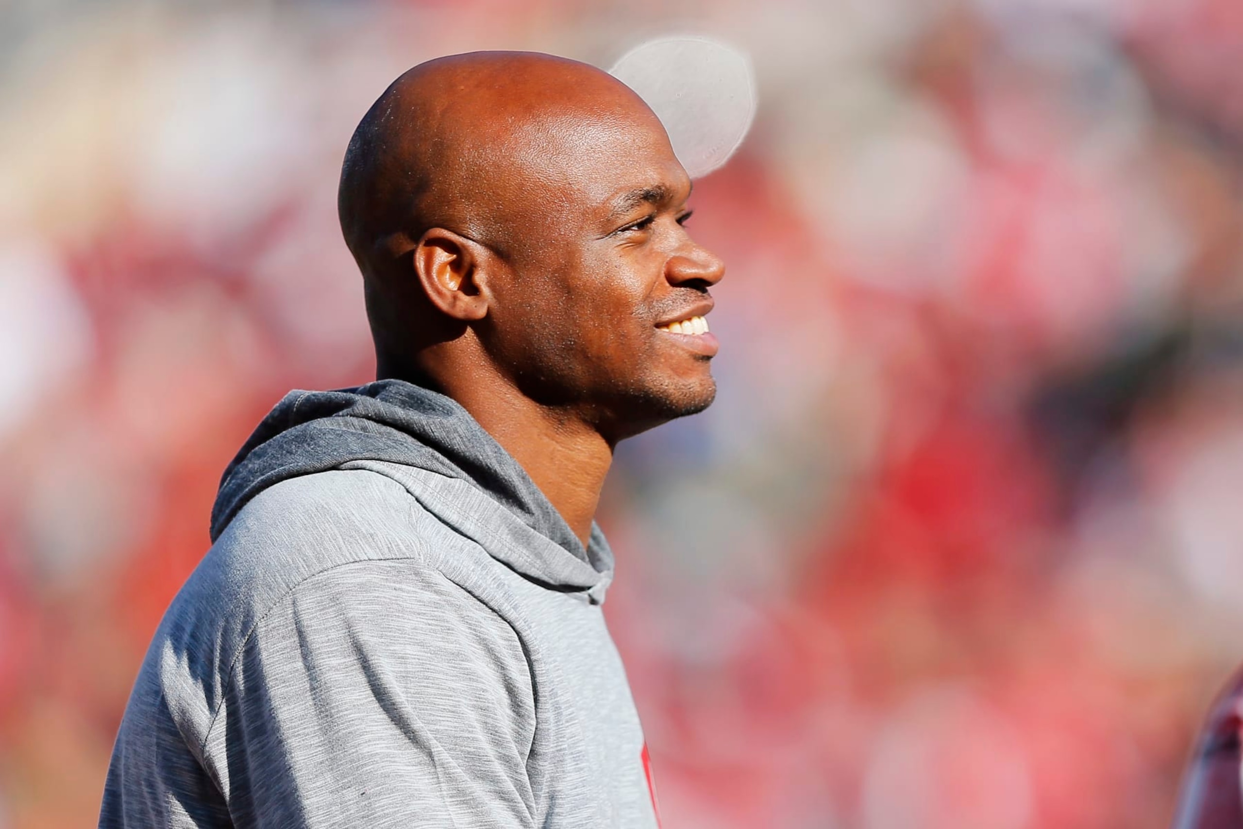 NORMAN, OKLAHOMA - NOVEMBER 24:  Running back Adrian Peterson smiles as he is recognized during a game between the Oklahoma Sooners and the TCU Horned Frogs at Gaylord Family Oklahoma Memorial Stadium on November 24, 2023 in Norman, Oklahoma.  Oklahoma won 69-45. (Photo by Brian Bahr/Getty Images)